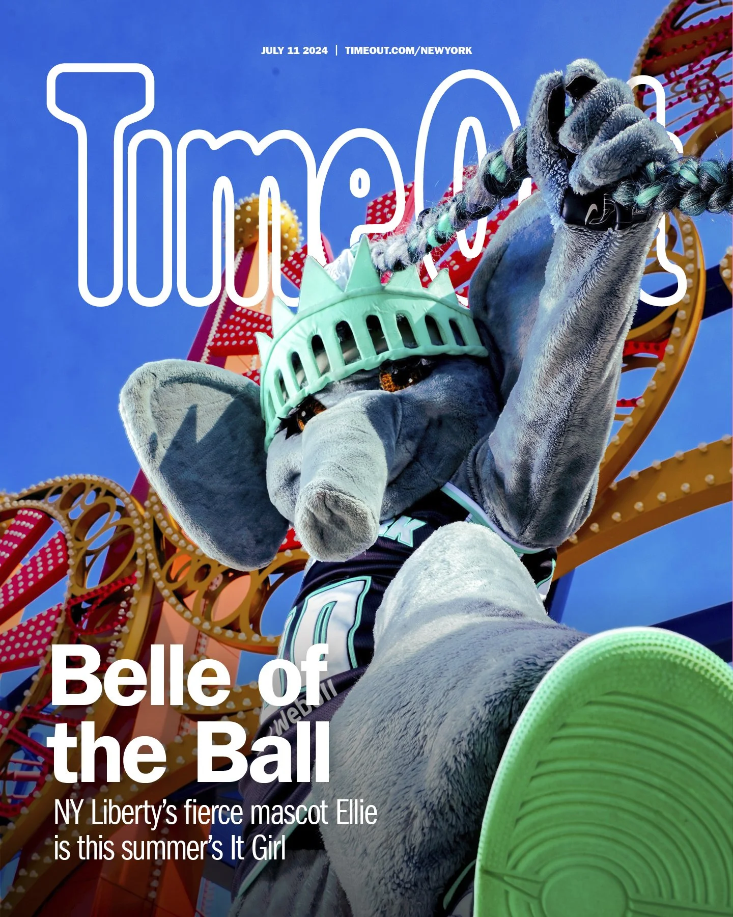 NY Liberty mascot Ellie, a large elephant in a basketball uniform, at an amusement park with a rollercoaster in the background, wearing a Statue of Liberty crown, promoting summer entertainment.