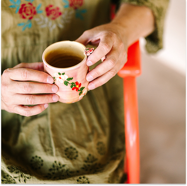 Amy Frost holding a cup of tea.