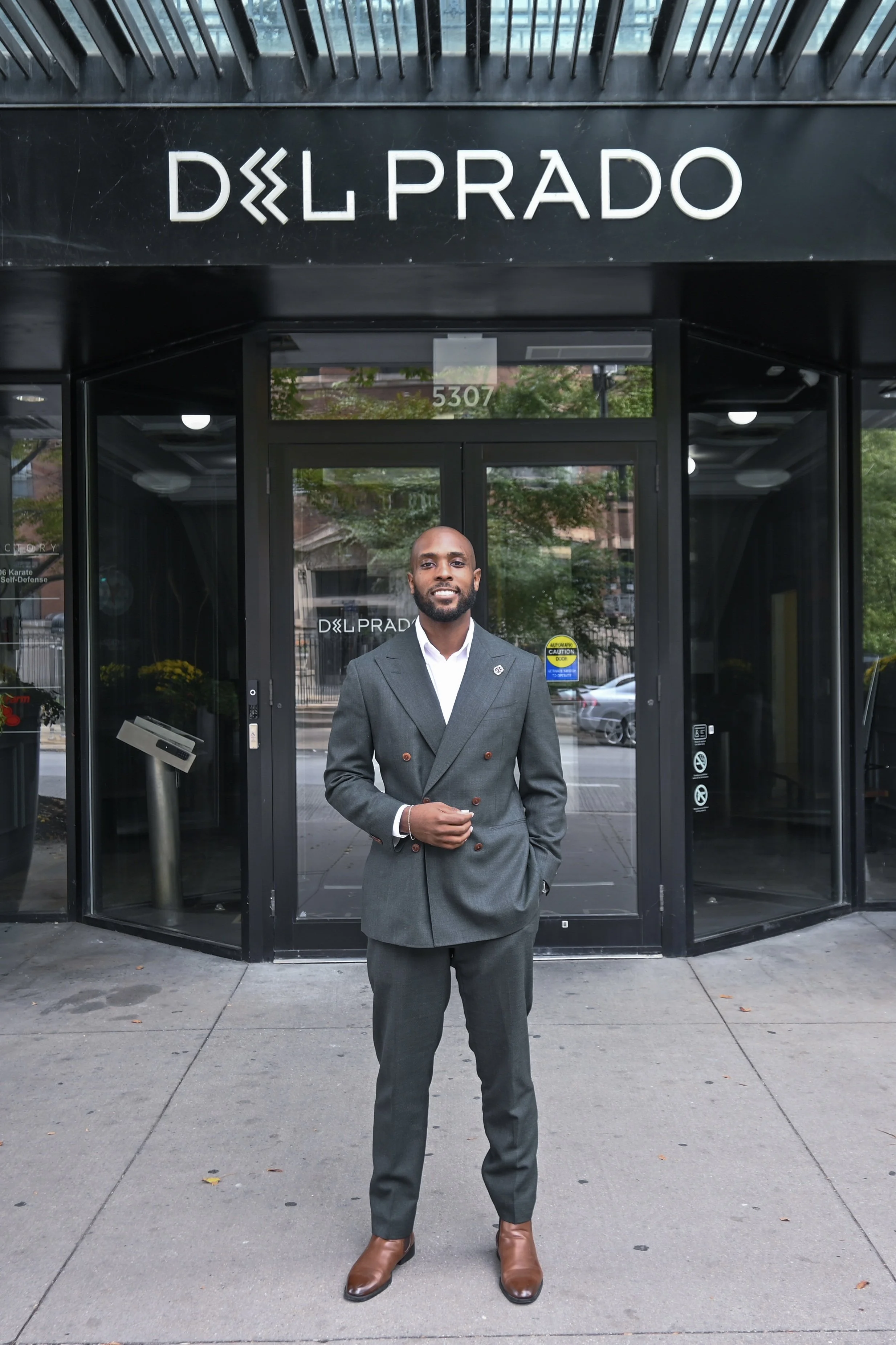 NWM Hyde Park's Brandon Lamar Standing in Front of Del Prado Building.