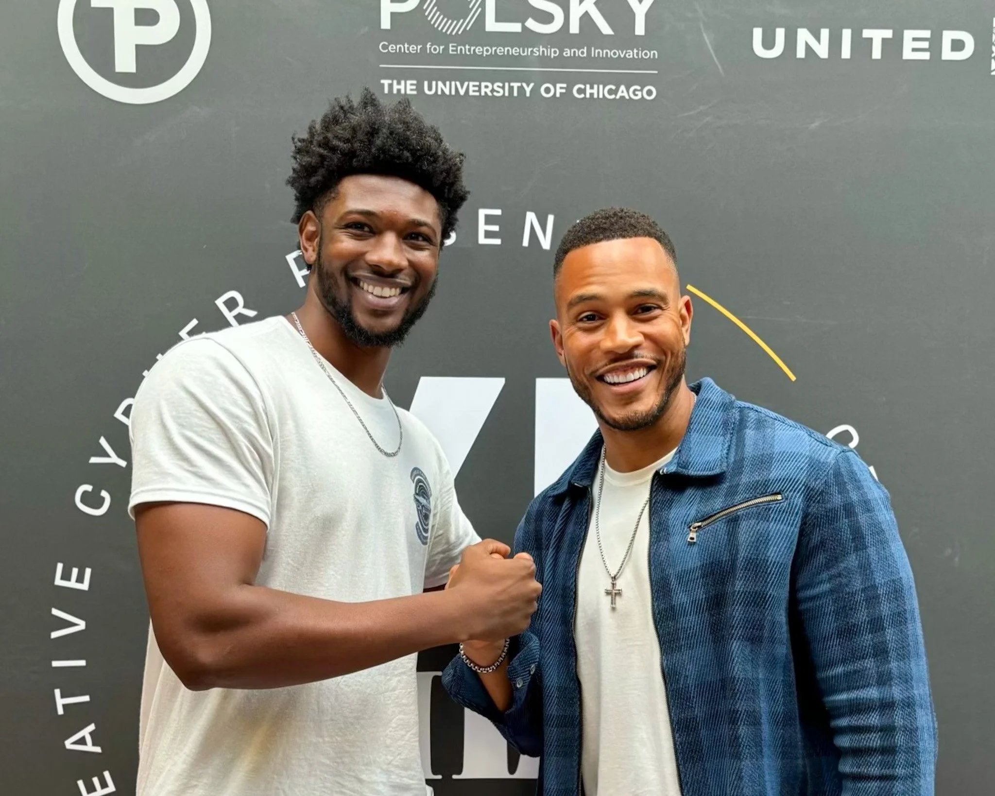 Two smiling men shaking hands at an event, standing in front of a black backdrop with logos and text, including 'POLSKY', 'Center for Entrepreneurship and Innovation', and 'The University of Chicago'.