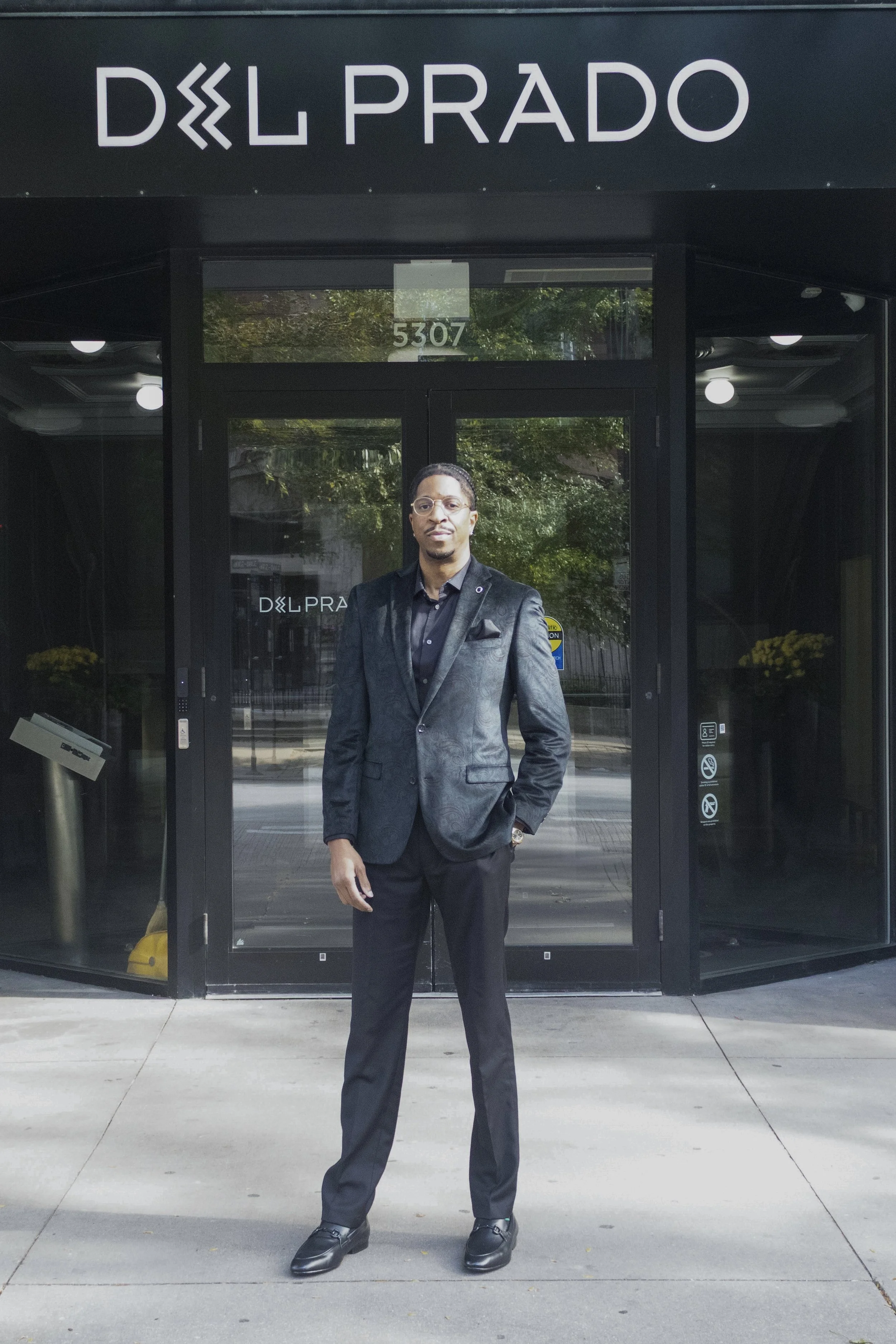 NWM Hyde Park's Aarin Haney Standing in Front of Del Prado Building.