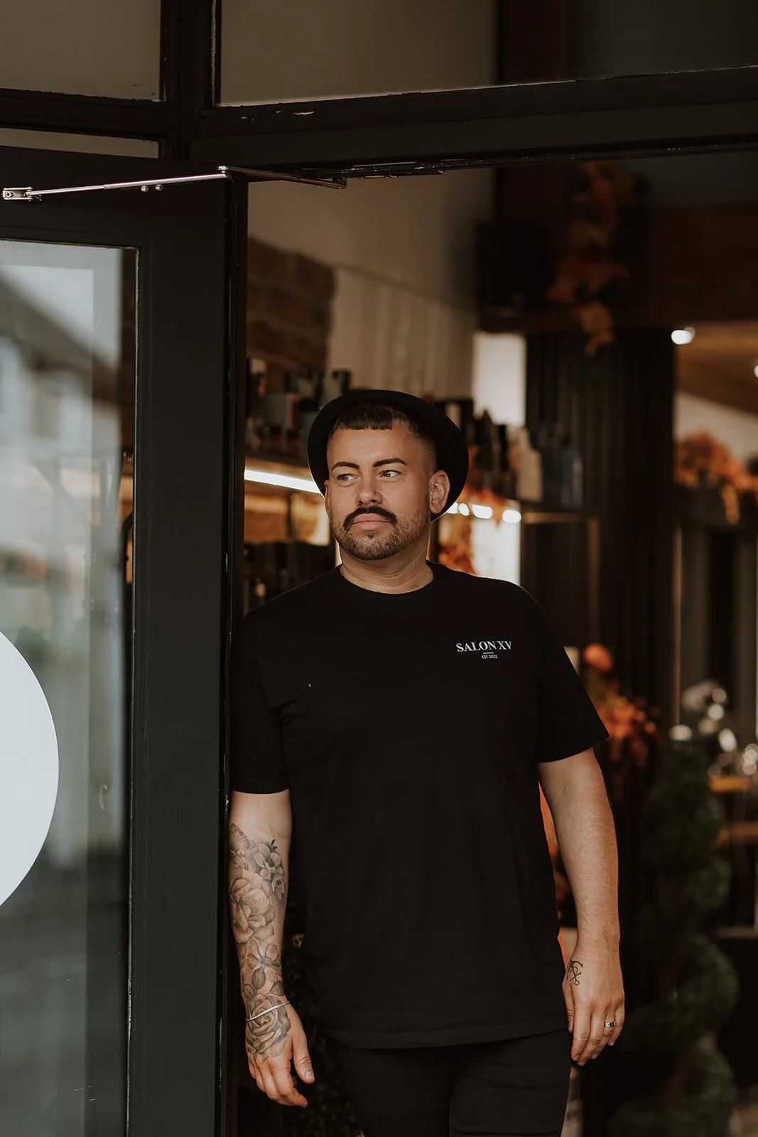 Sam Lewis-Evans standing outside Salon XV in Oswestry