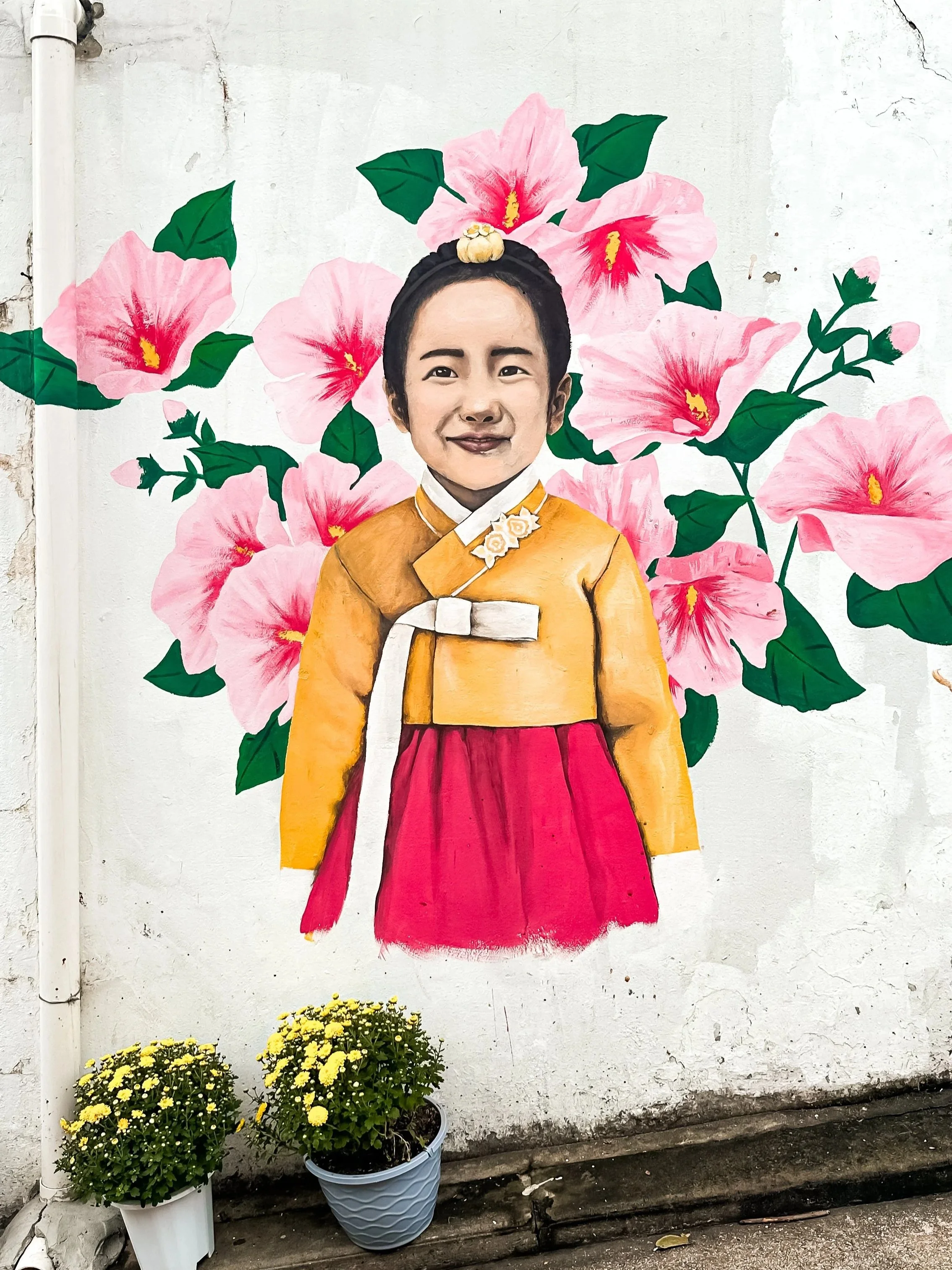 wander-senses-Bukchon-Hanok-Village-korean-woman-painting-on-the-wall-seoul-south-korea.jpg