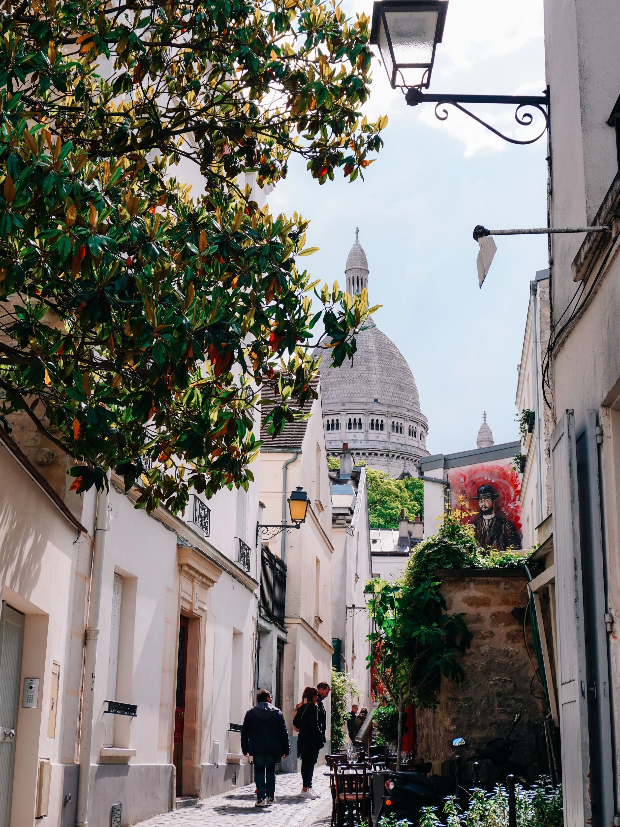 Montmartre in early July, during the week, is probably my favorite version of it.

The soft morning light, the quiet streets before the crowds arrive, the textures of old fa&ccedil;ades, faded shutters, caf&eacute;s slowly opening. Everything feels c