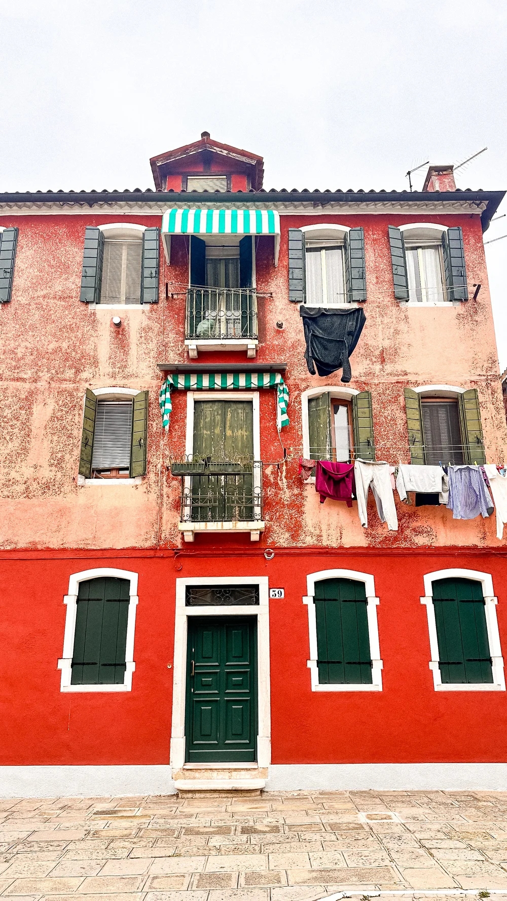 wander-senses-murano-red-building-with-clothes-hanging-to-dry.jpg
