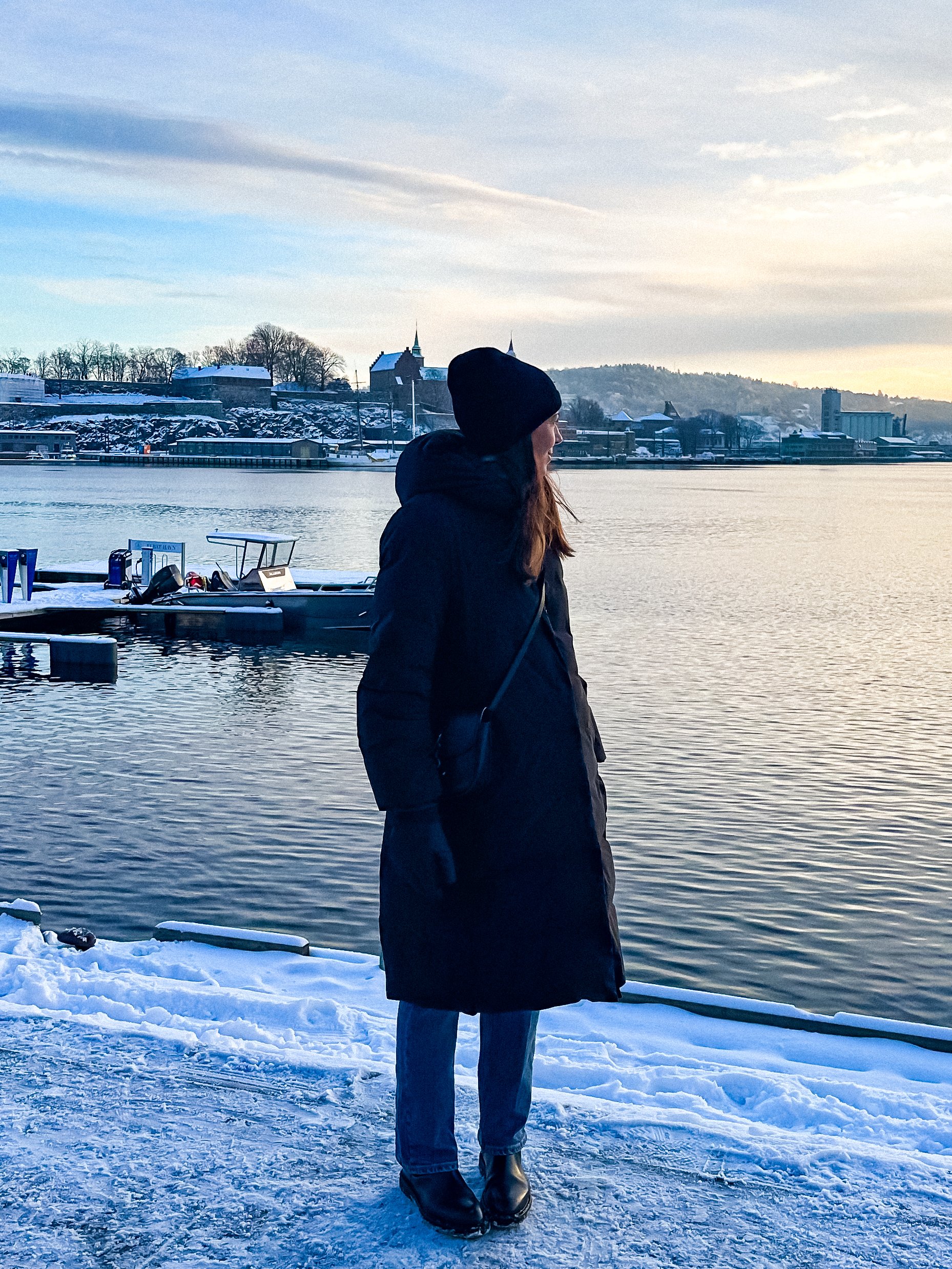 wander-senses-norway-oslo-woman-at-harbor-covered-with-snow.jpg