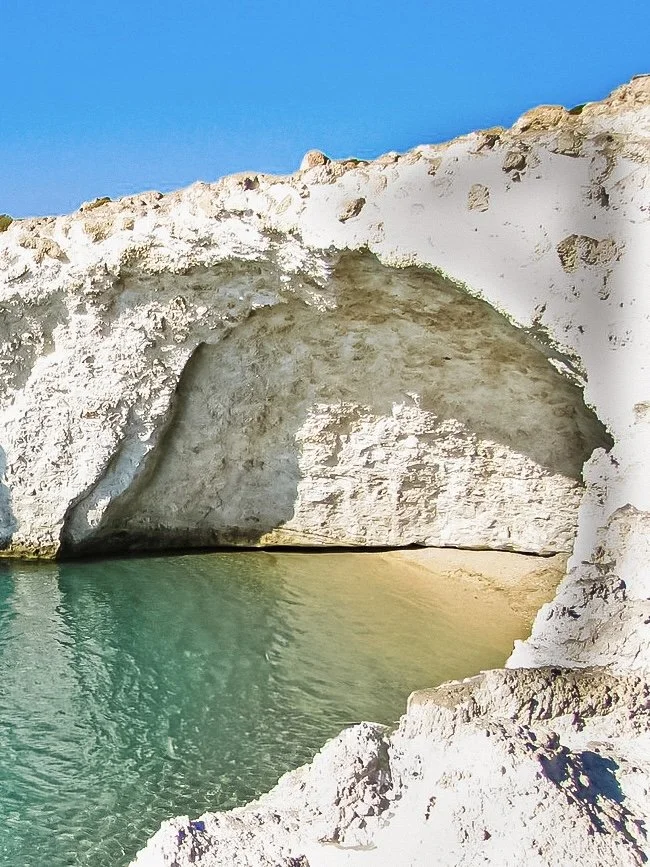 Volcanic white cliff with blue water of Alogomandra beach in Milos