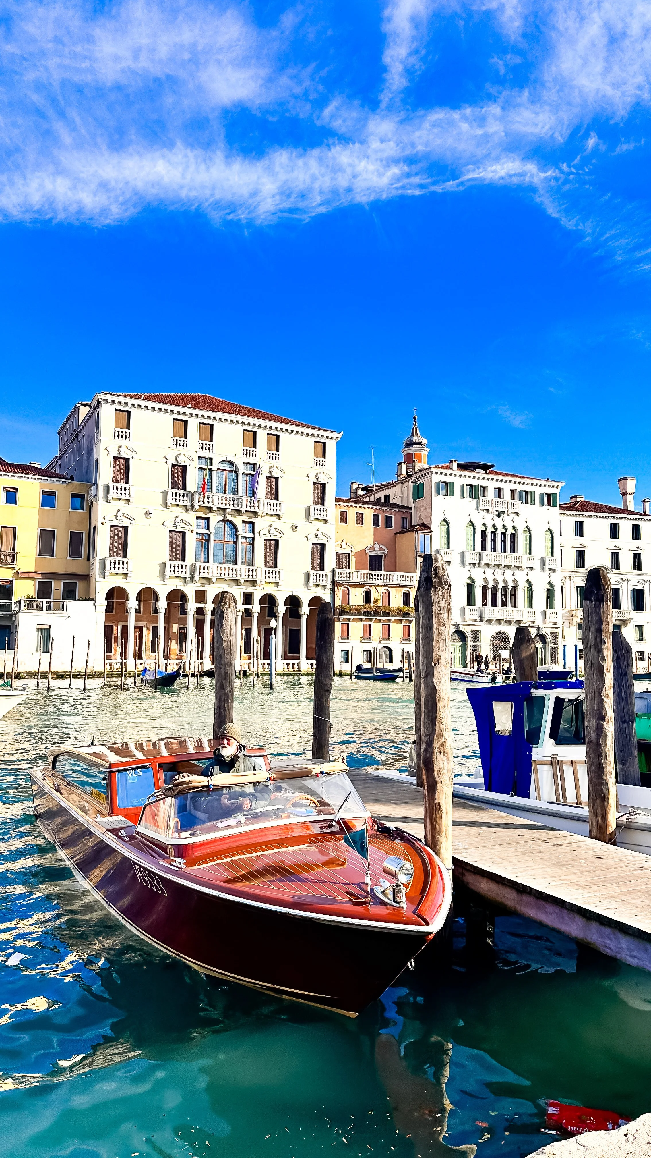 wander-senses-venice-wooden-boat-parked-on-canal.jpg