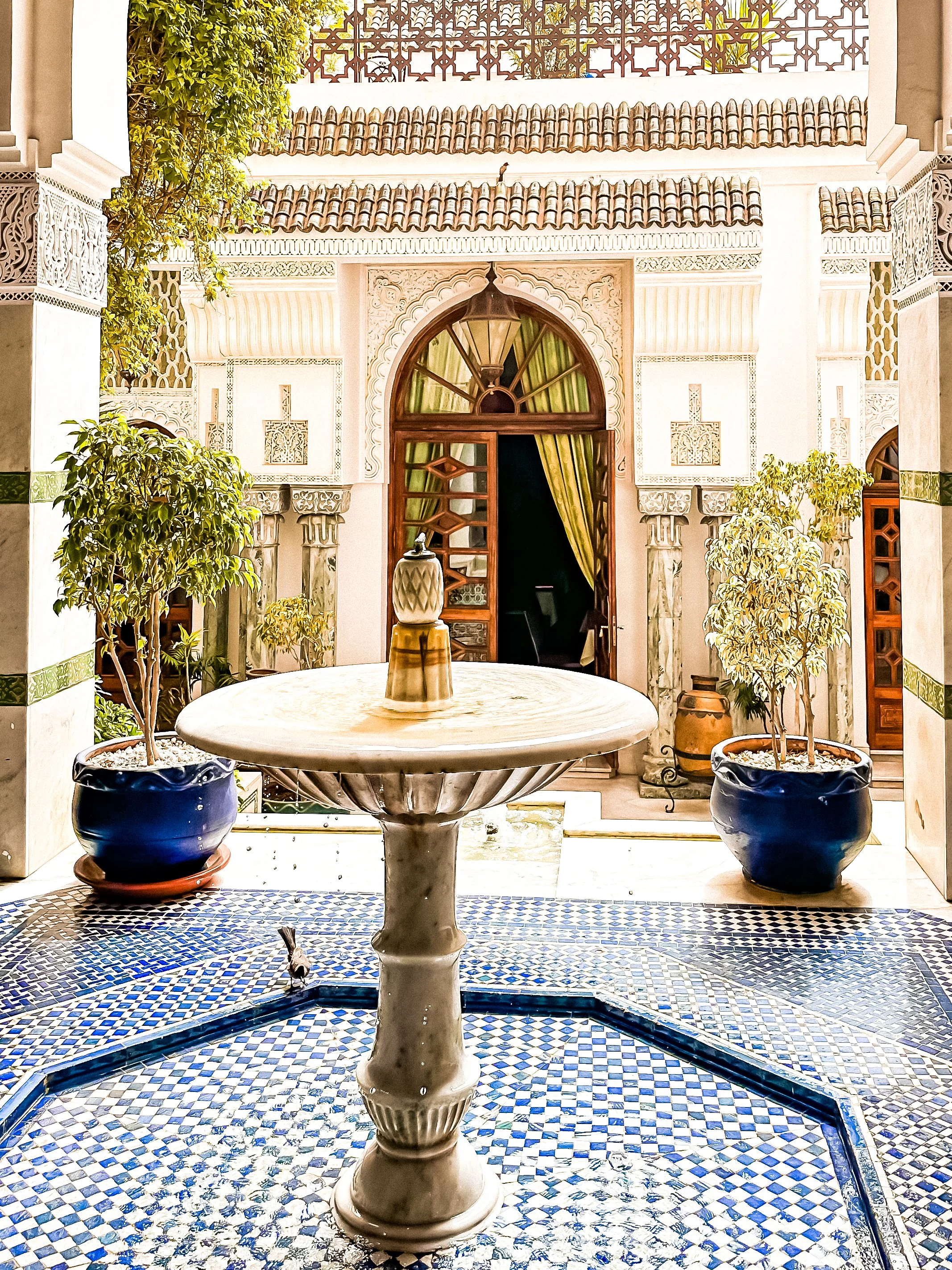 entrance of a riad with a fountain inside the medina of Marrakech