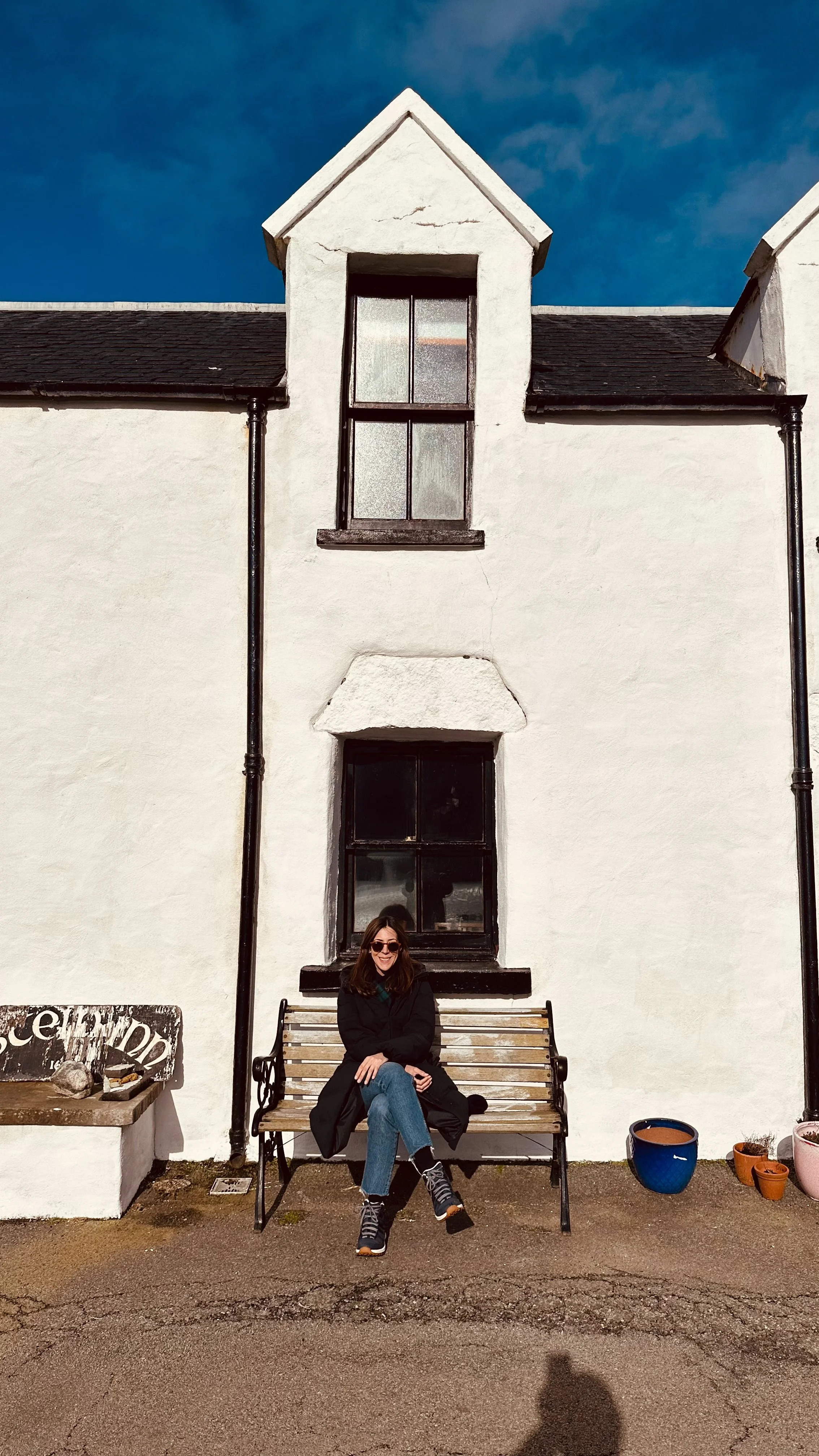 wander-senses-woman-sitting-in-front-of-inn-skye-island-scotland.jpg