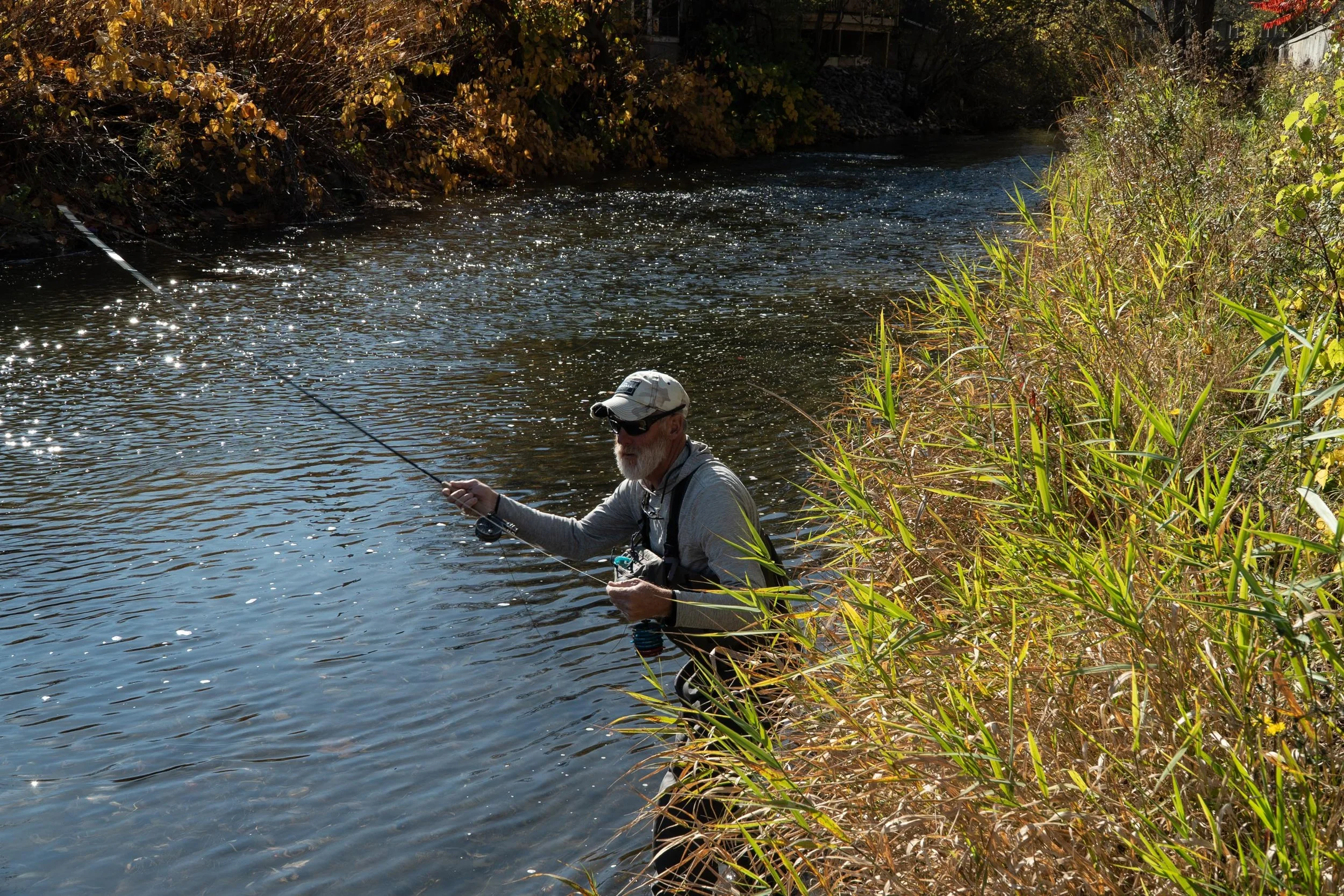 Mike Crawford stands on the edge of the Ninemile Creek fishing for trout. This is Mike’s 23rd year as an outdoor guide, and he recalls noticing changes in the fish and water around twelve years ago. “I've always kind of been in it, in the local envir