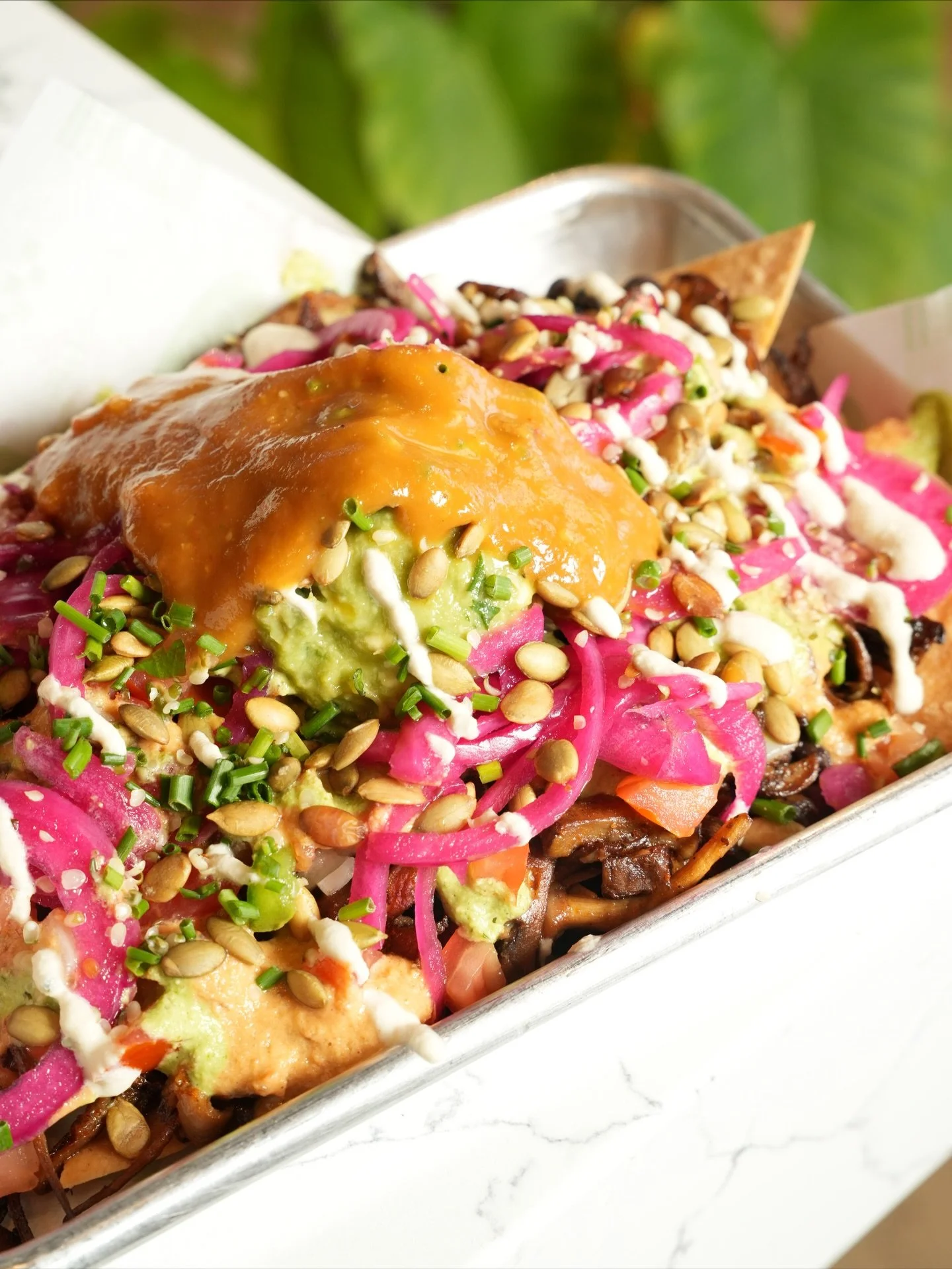 Our loaded nachos, made with fresh cassava chips topped with mushroom &ldquo;carnitas,&rdquo; black beans, guac, pico, chipotle crema, cilantro-lime sauce, pumpkin seeds, and pickled red onion. 

Want to level it up? Sub wild venison instead 😎