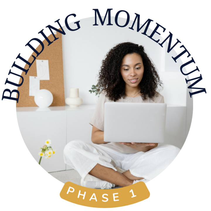 A young woman sitting cross-legged on the floor using a laptop, with a decoration board and vases in the background, and text overlay saying 'Building Momentum Phase 1'.