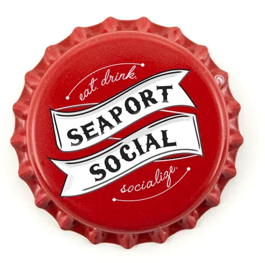Red bottle cap with white and black text that reads 'eat drink, SEAPORT SOCIAL, socialize'.