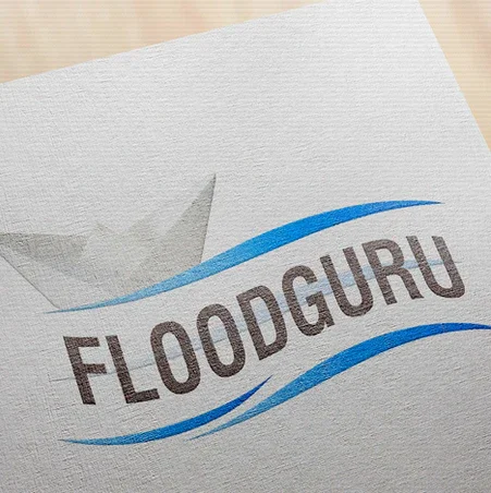A logo with the word 'FLOODGURU' and blue wave lines on a piece of paper.
