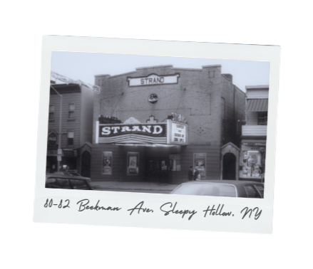 Black and white photograph of the Strand theater on Betkman Avenue in Sleepy Hollow, NY, with visible marquee and building details.