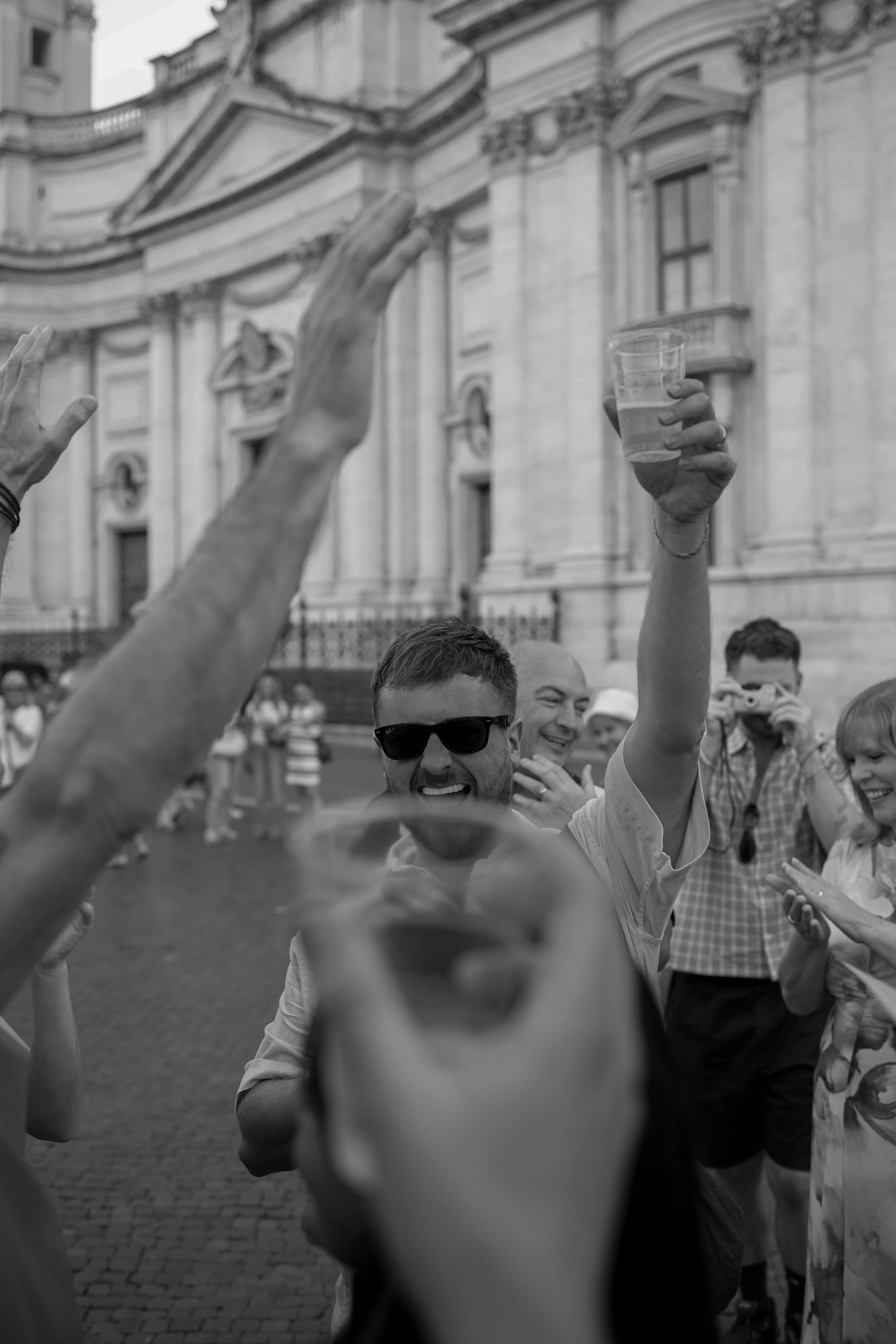 man raising his glass in celebration