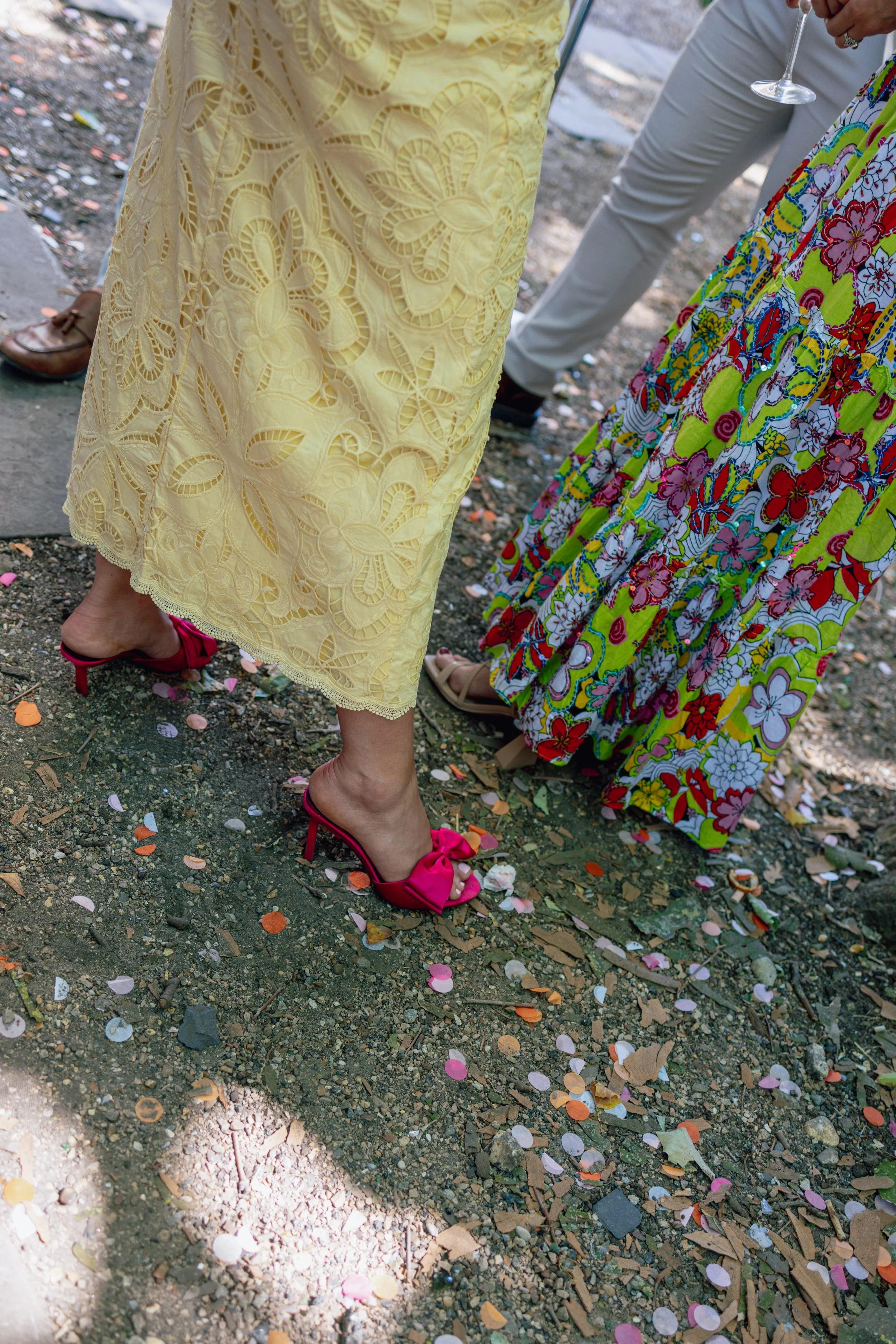 confetti on floor with women's dress and shoes showing