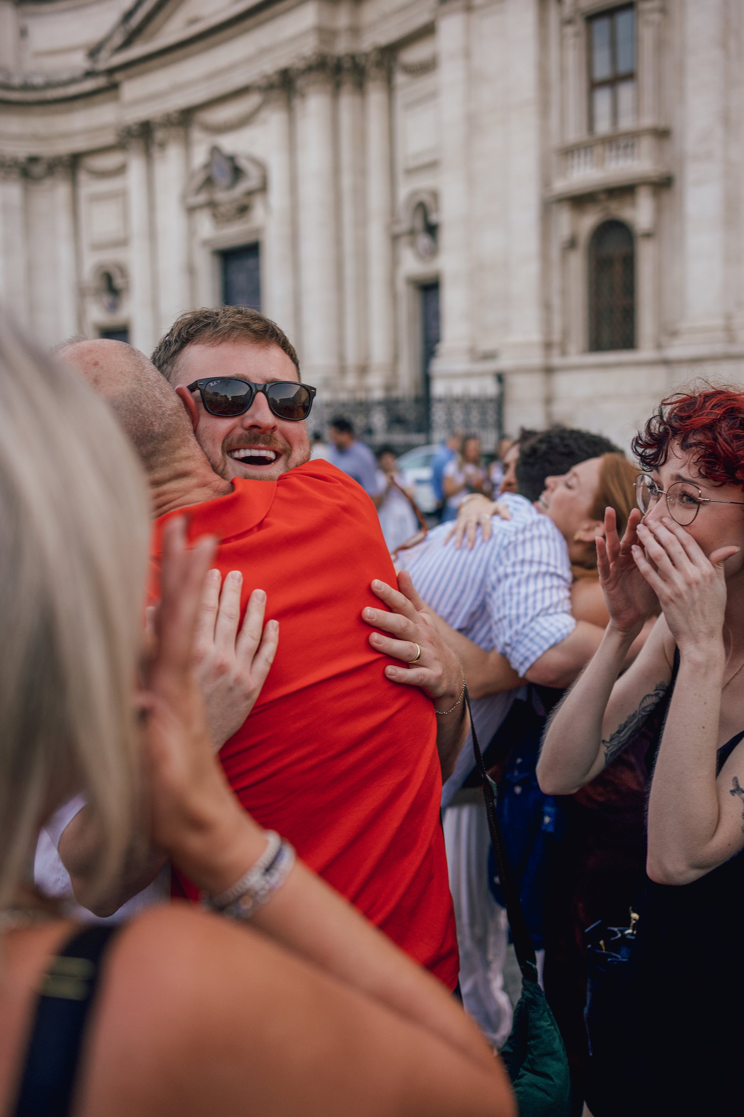 man hugging another man at his engagement