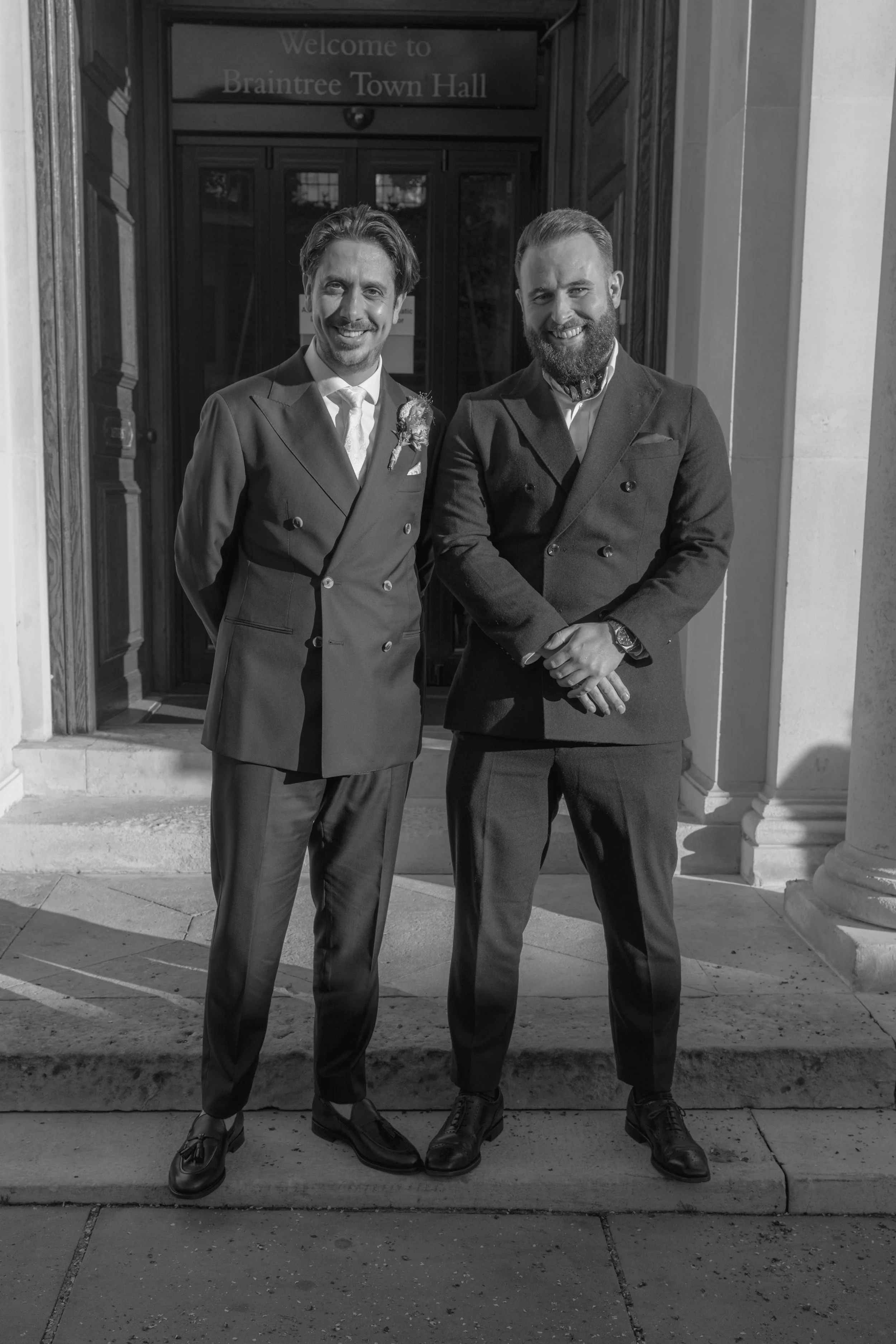groom and groomsman smiling