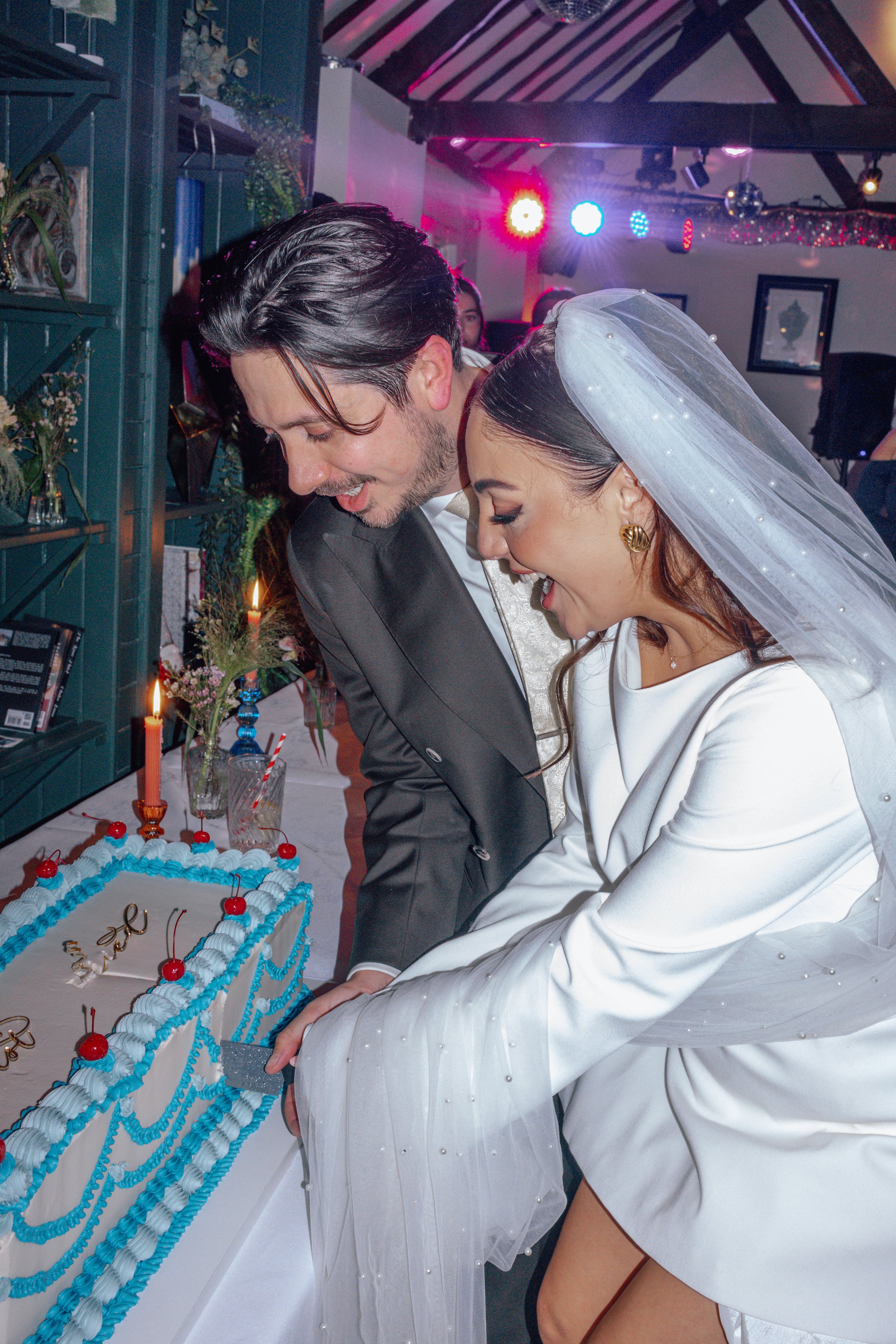 bride and groom cutting the cake