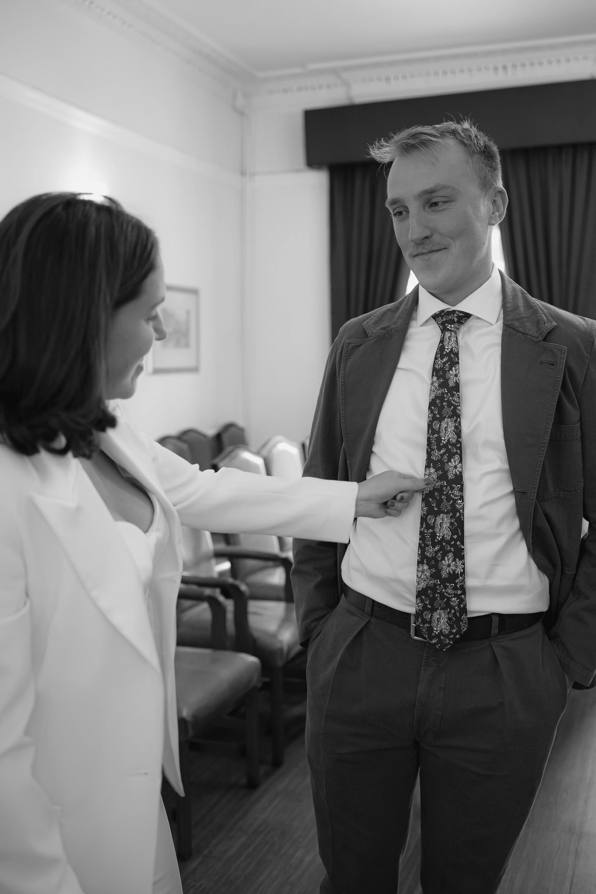 bride adjusting grooms tie
