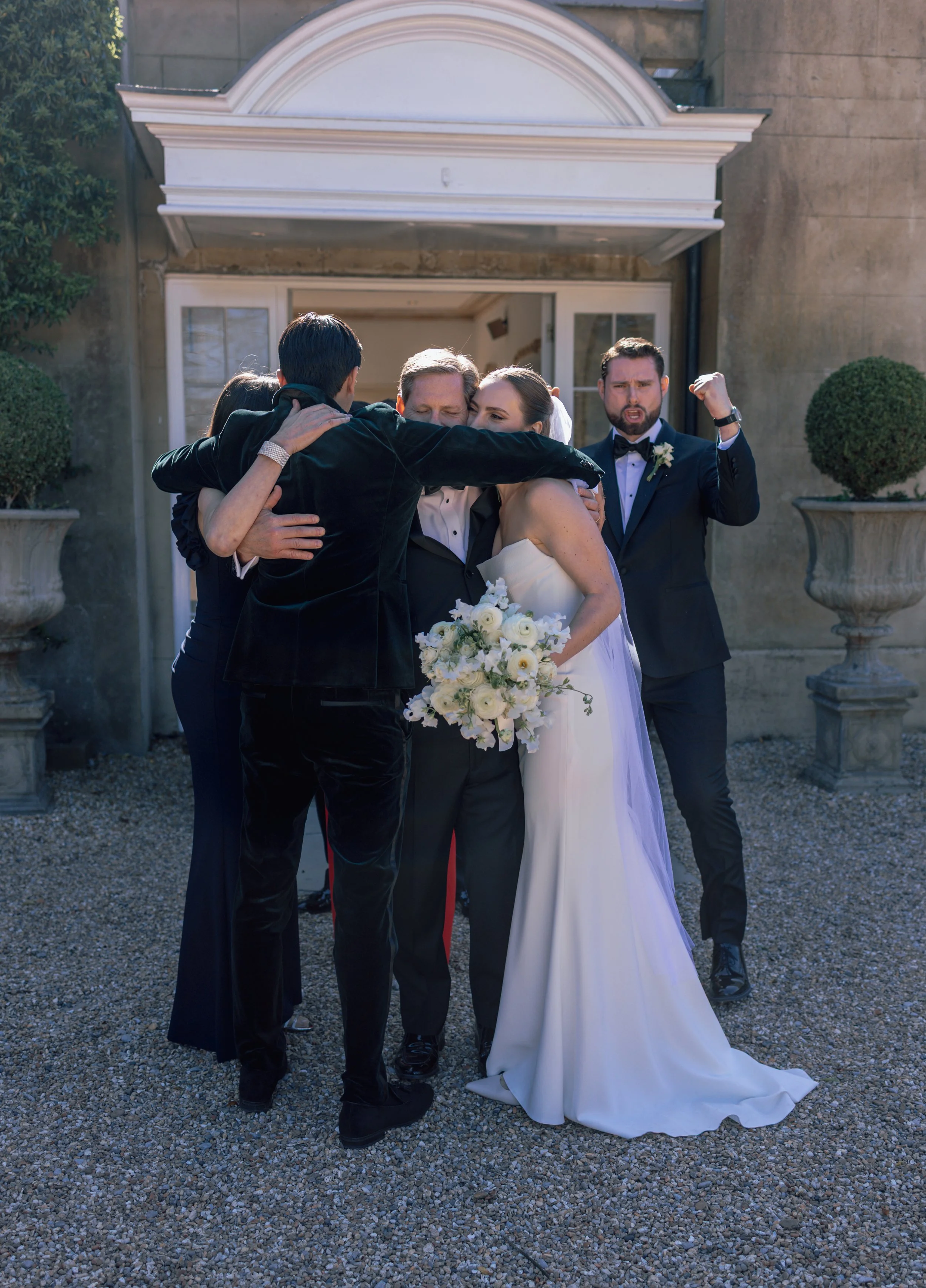 a family embracing after wedding ceremony
