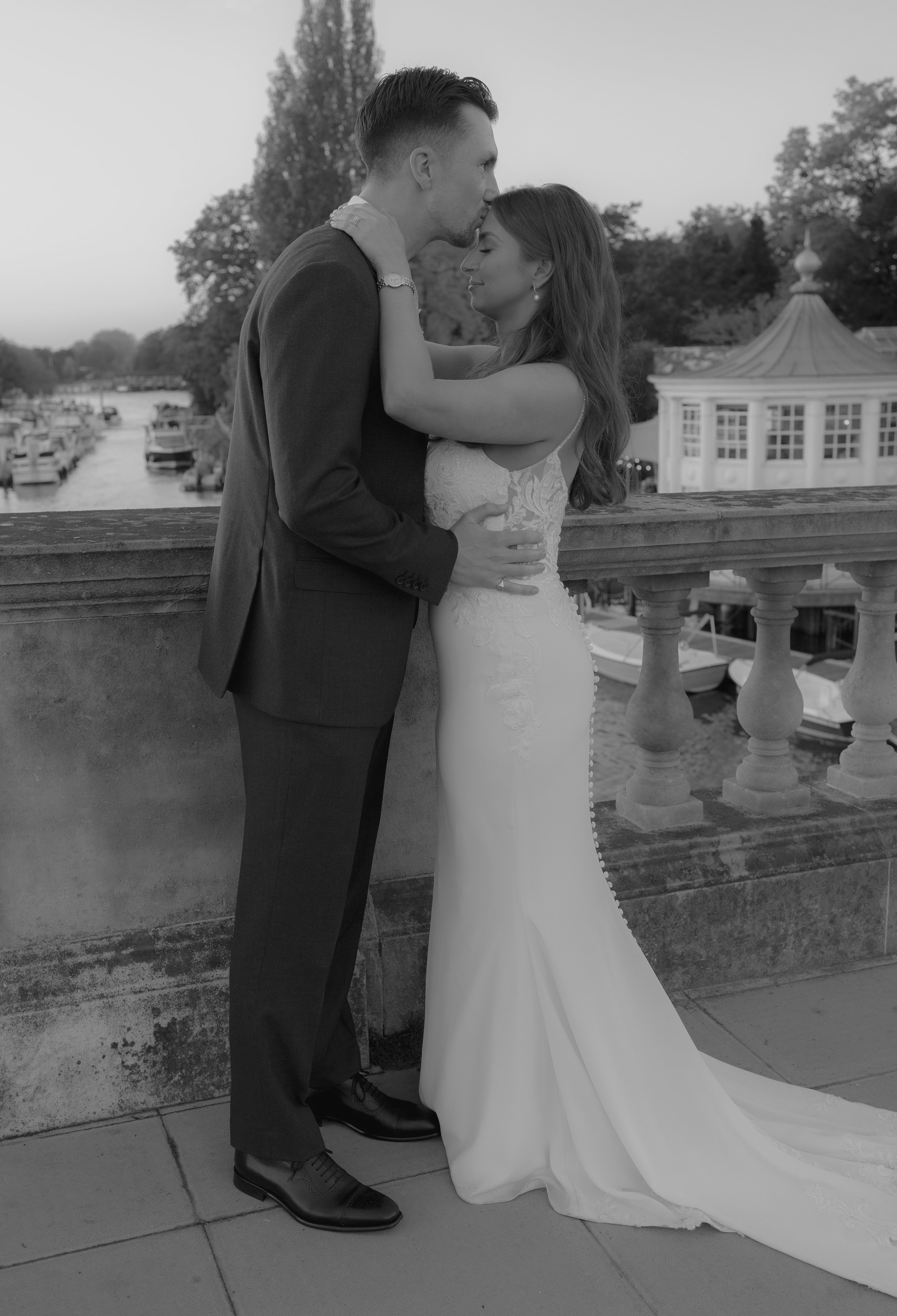 groom kissing bride on the forehead
