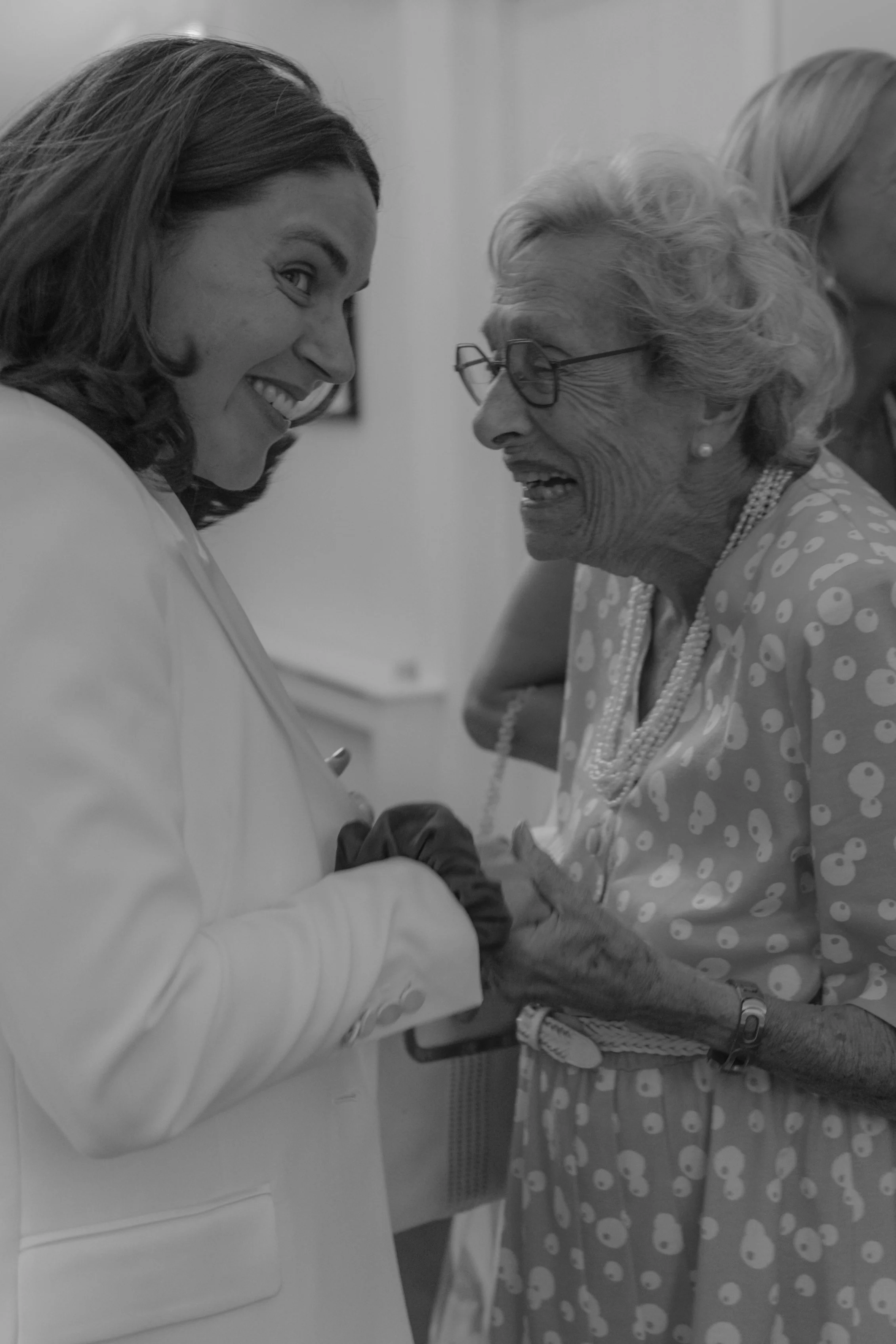 bride holding grandmothers hands and laughing