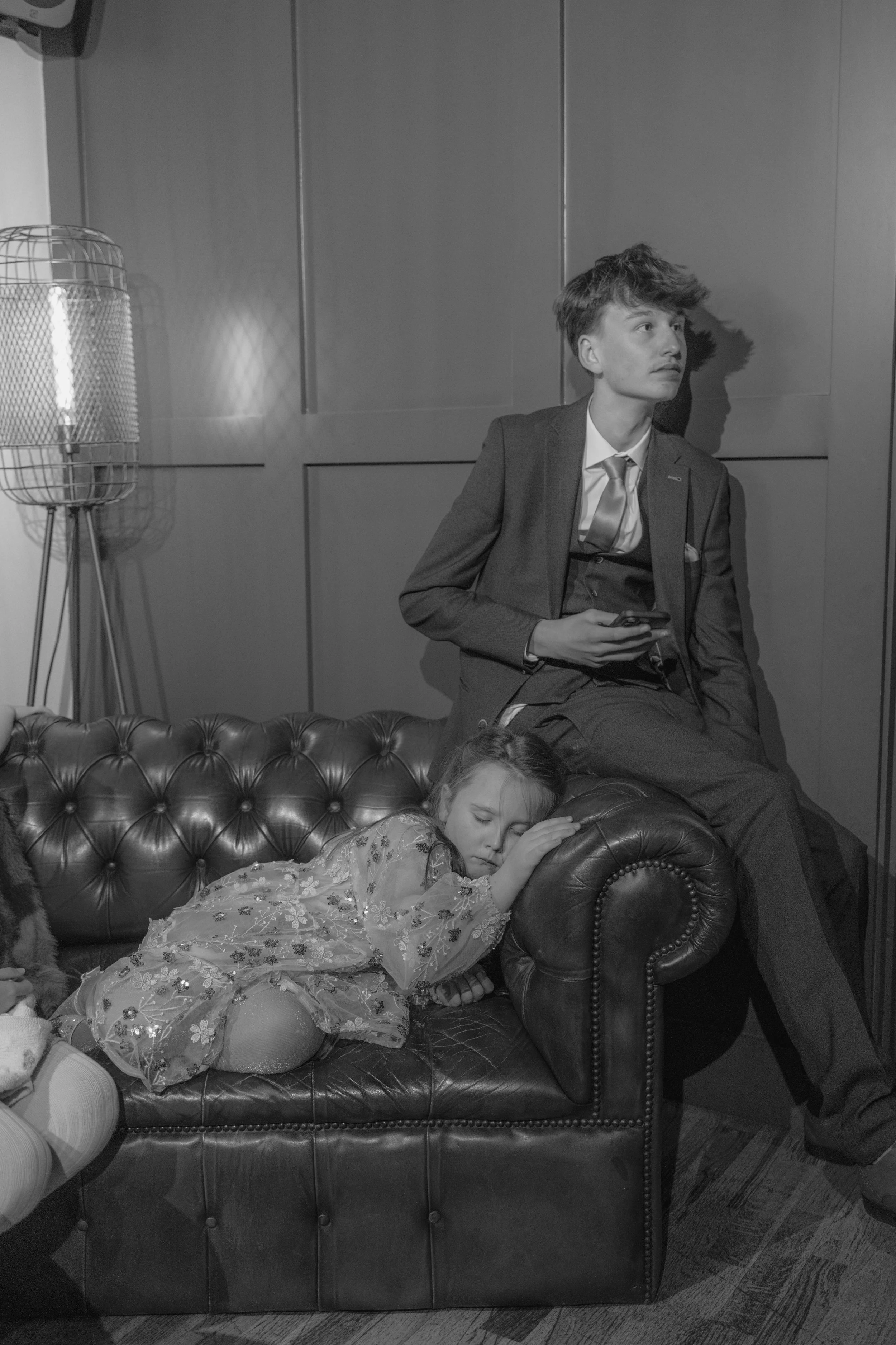children asleep on a sofa during wedding reception