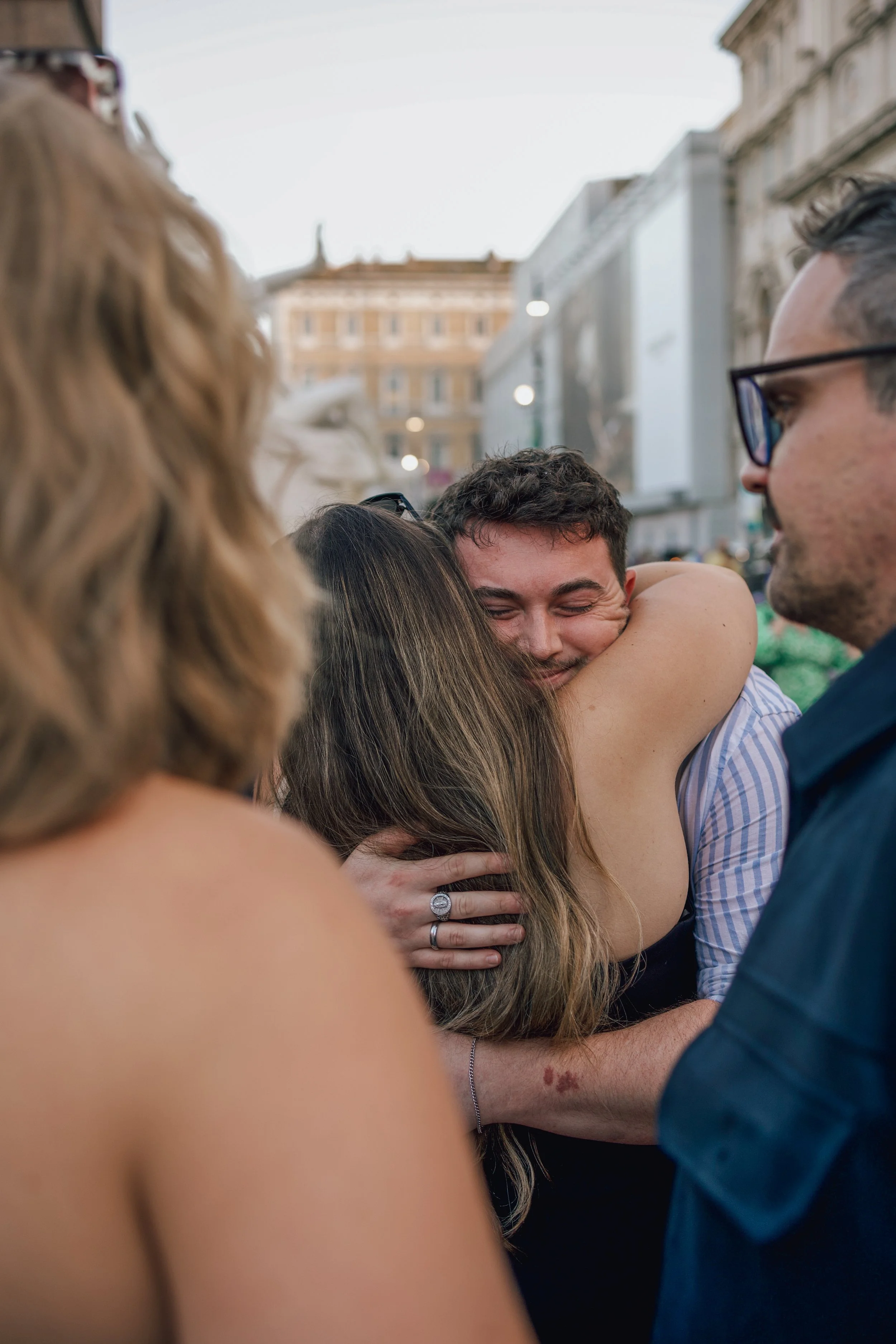 man hugging his friend after getting engaged