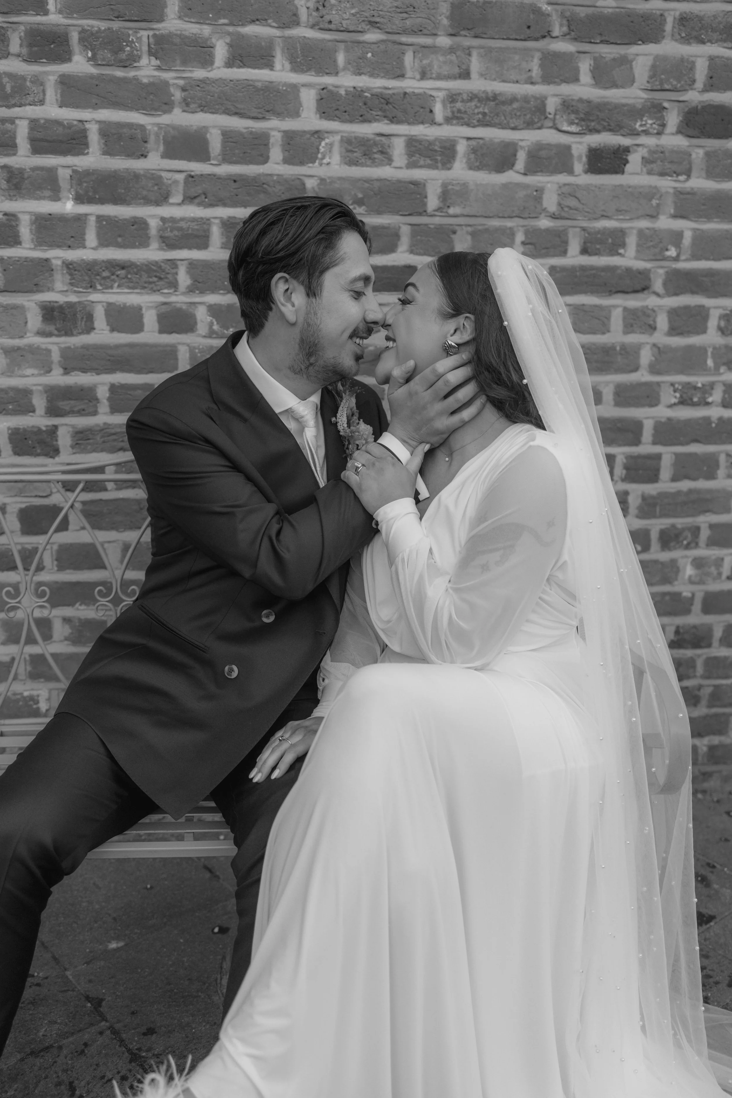 groom and bride going in for a kiss 