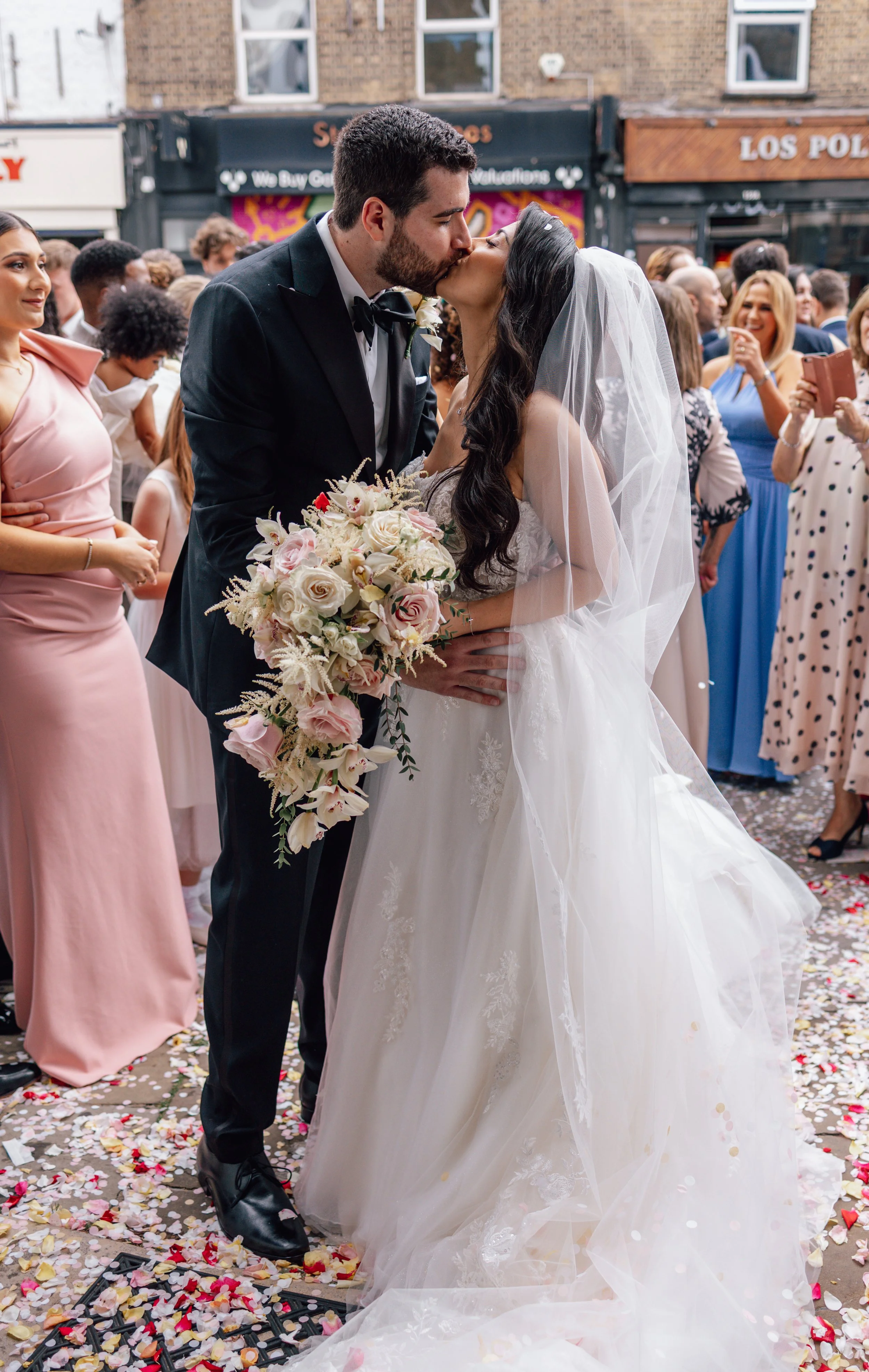 bride and groom kissing outside church