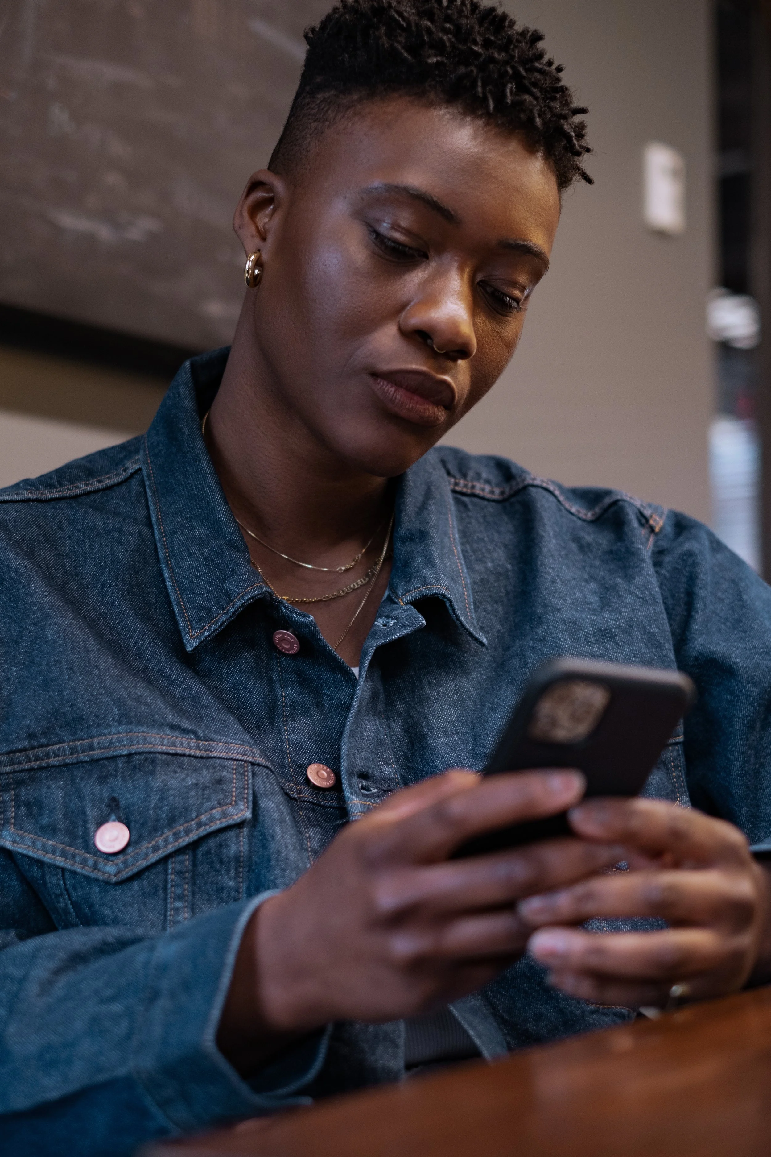 A non-binary person looking at a cellphone(5).jpg