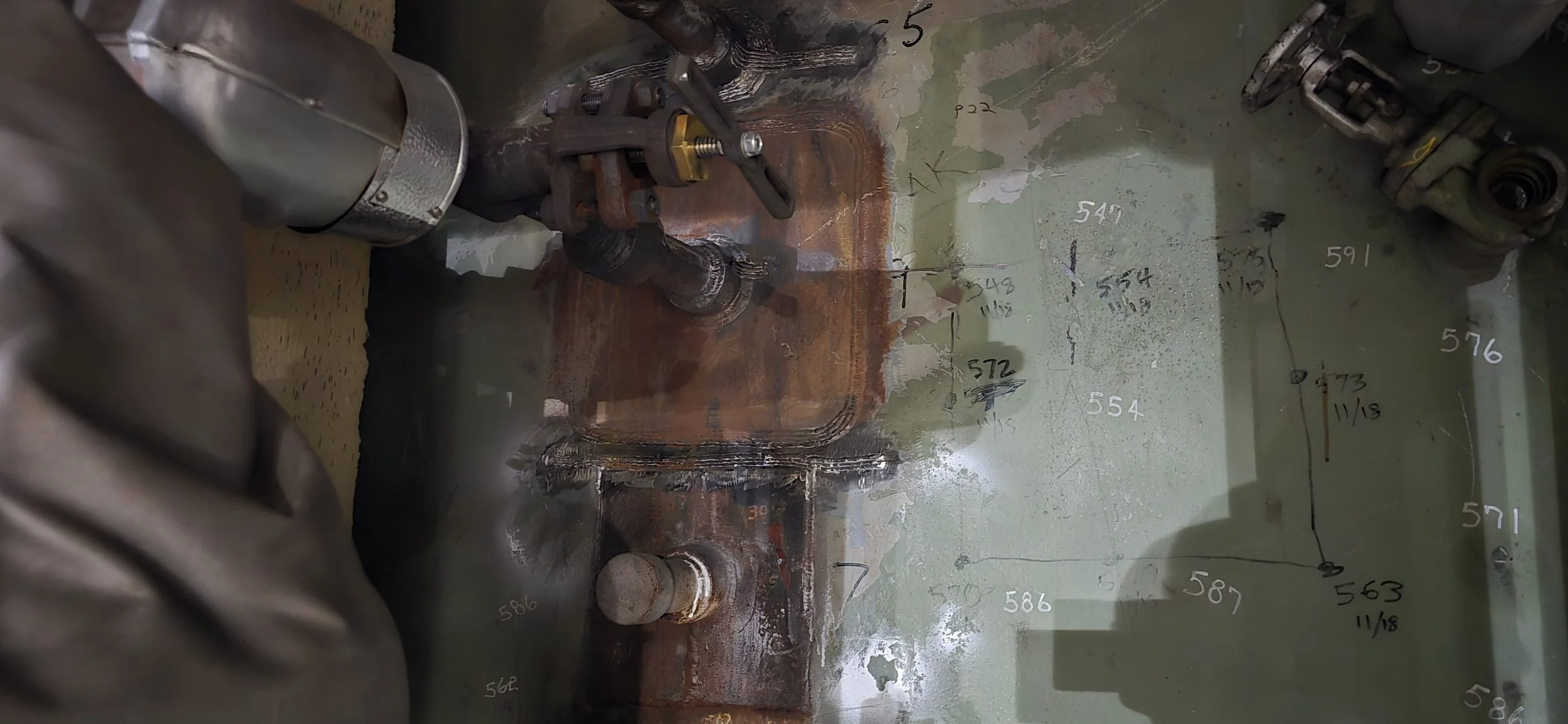 West side of the Condenser, a whole bunch of heater drain connect into the condenser / hotwell. A major leak was identified at a fossil power plant. This is a close up of the header penetration connecting to the condenser / hotwell crack on weld.