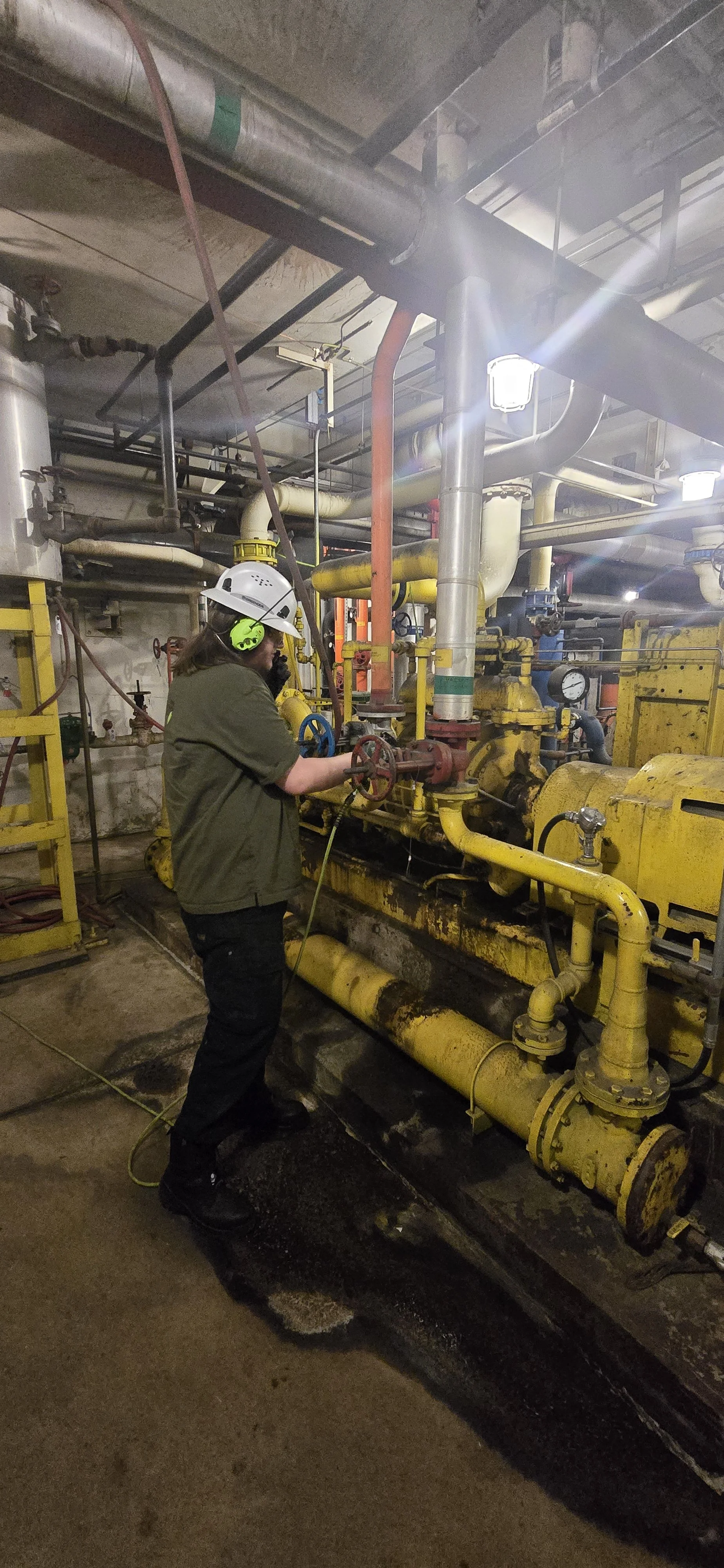 Sylvan one of our NDT Technicians at Absolute Maintenance Solutions performing condenser air inleakage testing on a vacuum pump in a fossil power plant. Leaks were identified on the shaft seals.