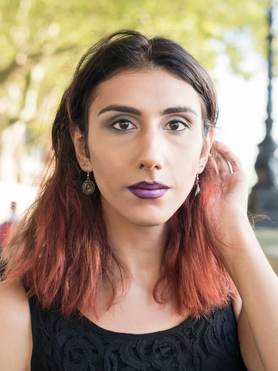 Woman with bold makeup looking directly at camera, representing LGBTQ+ affirming therapy in Newport, Oregon