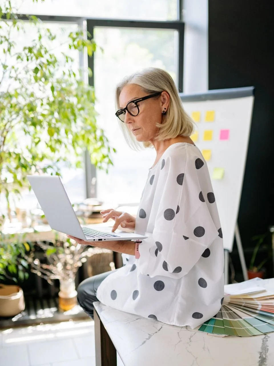 Woman working on a laptop, representing midlife transitions therapy in Newport, Oregon