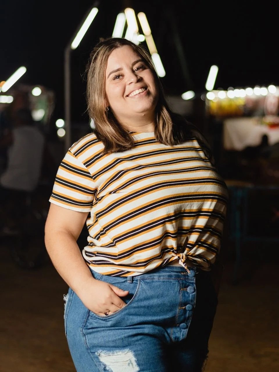 Confident smiling woman at night, representing body image and disordered eating therapy in Newport, Oregon
