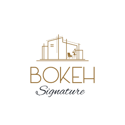 Logo for Bokeh Signature, featuring a stylized outline of a building with a small window, with a table and chairs inside, and the text "Bokeh Signature" below.