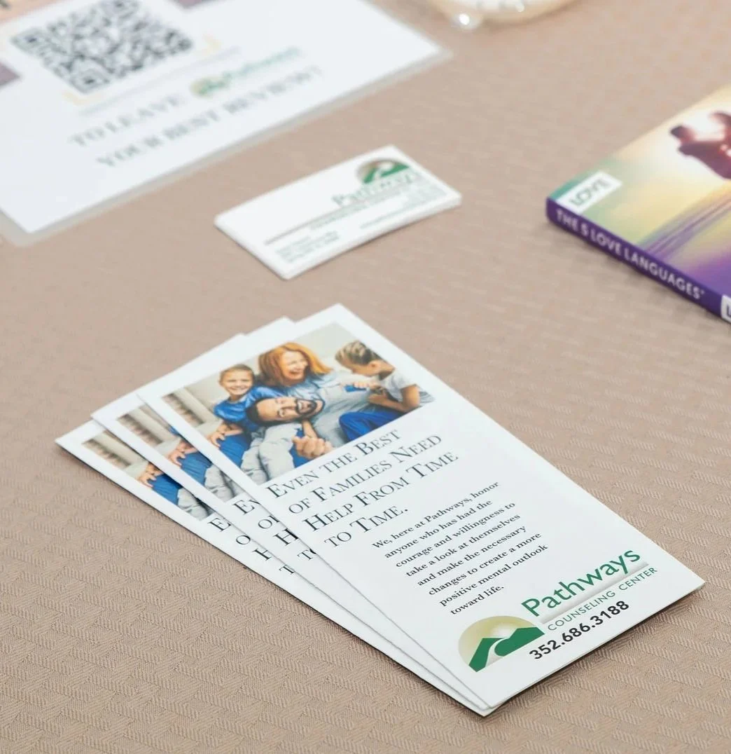 a fanned out pile of pathway brochures sitting on a desk