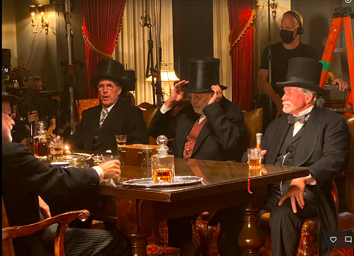 Dixey beside John at Table.png