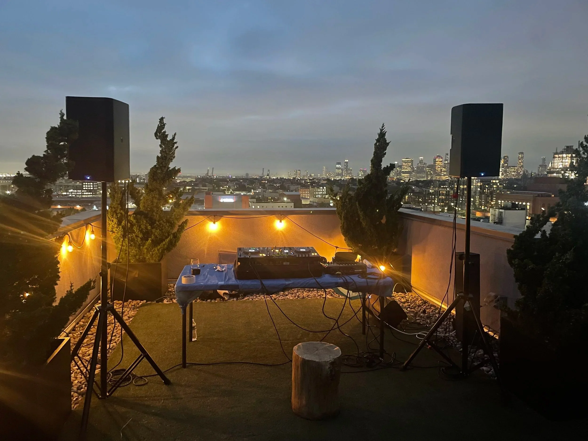 DJ booth and speaker setup at rooftop event in NYC
