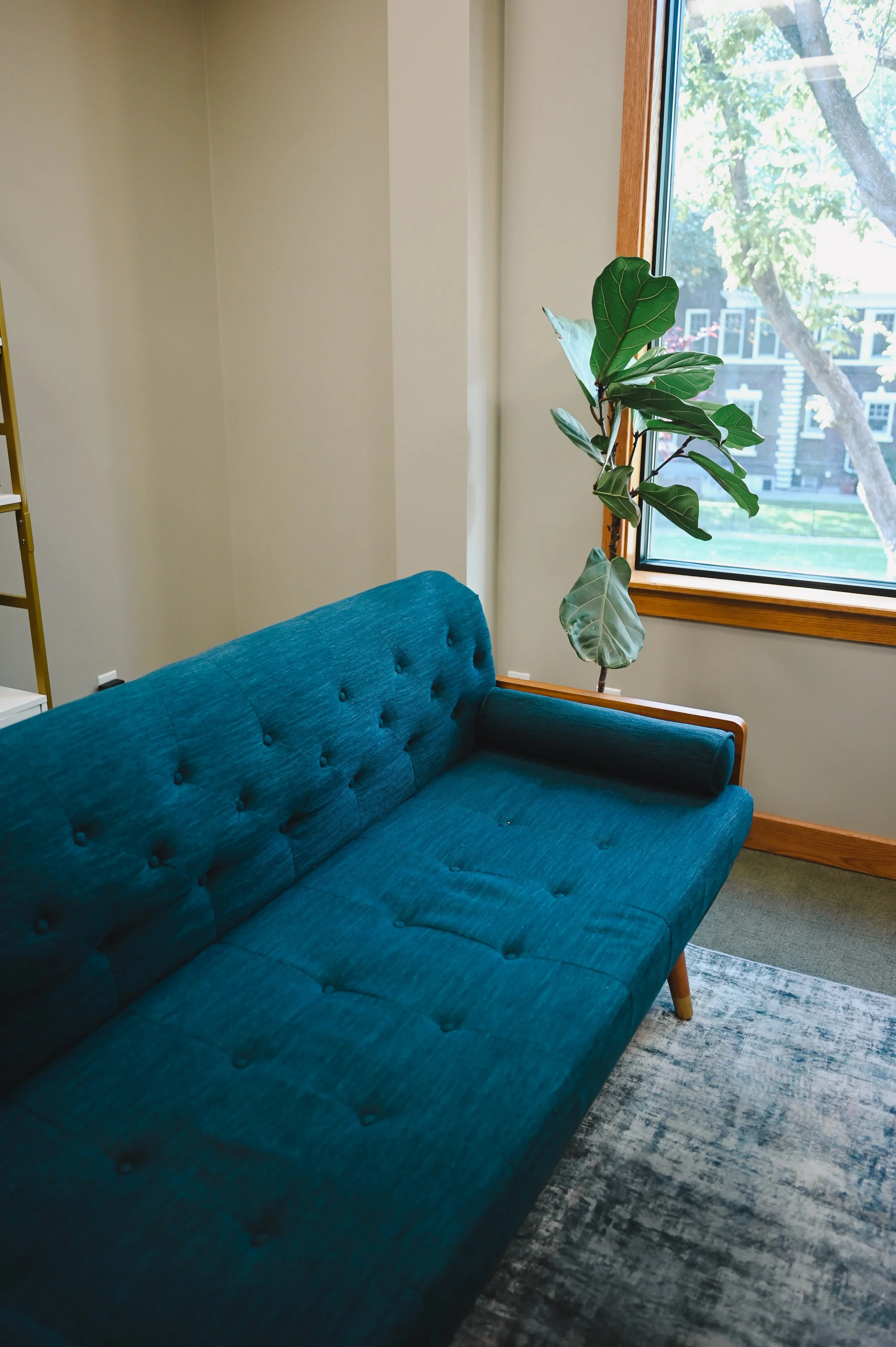 therapy office with a contemporary couch and private seating area at New Heights Counseling in Salt Lake City, Utah.