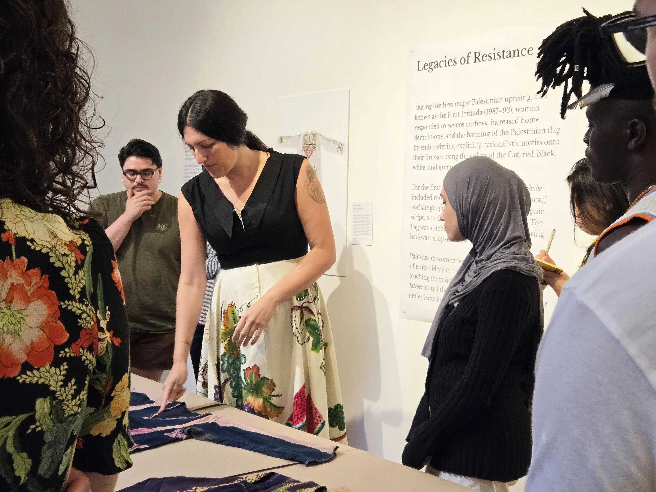  Wafa Ghanim presenting dresses from the exhibition. 