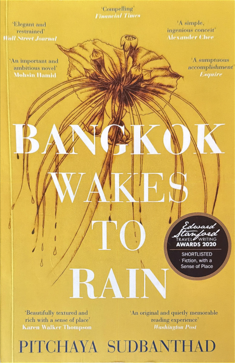 Yellow book cover of Bangkok Wakes to Rain by Pitchaya Sudbanthad, featuring a botanical illustration and large white title text.