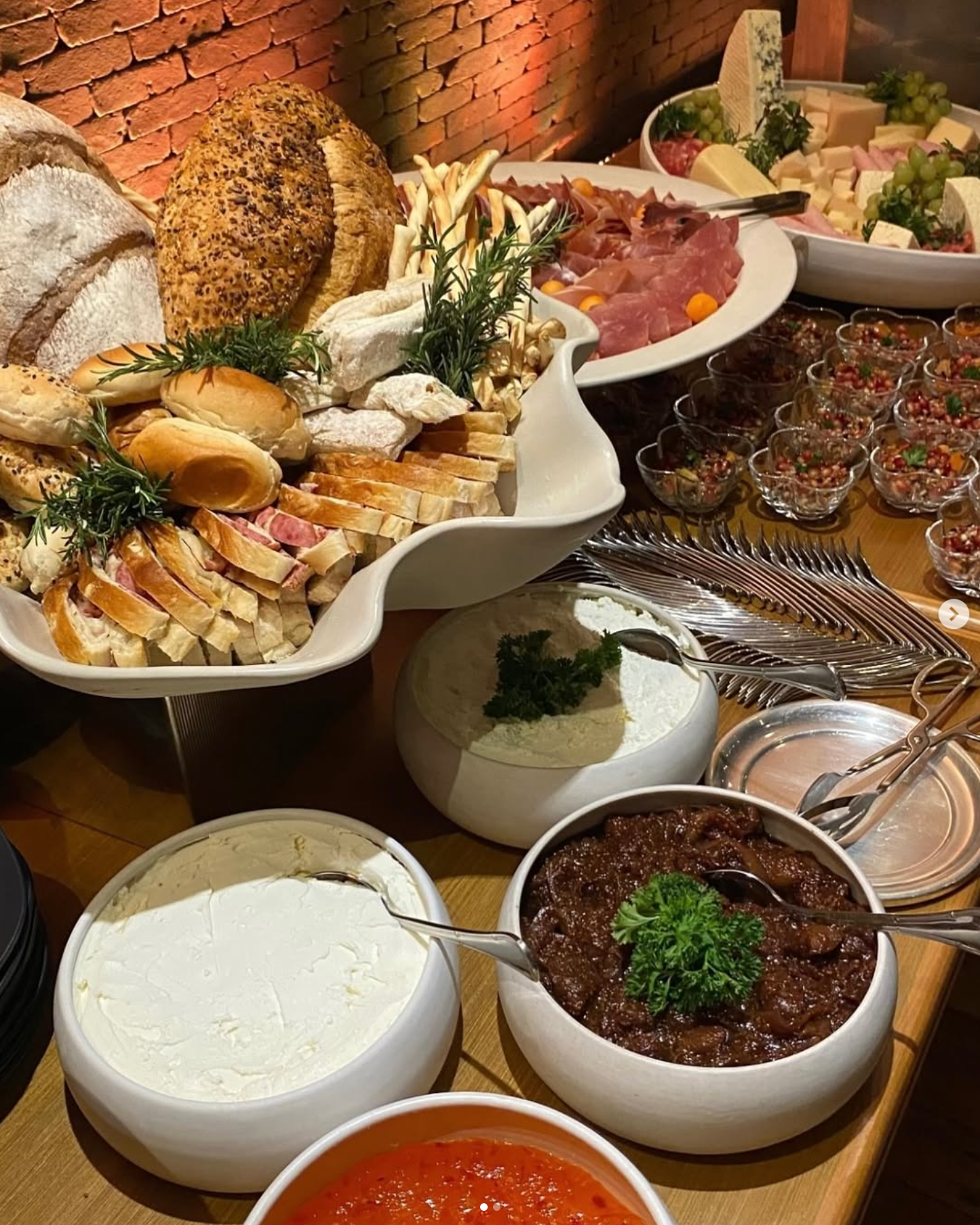 Mesa de queijos, frios, pães, pastas e acompanhamentos