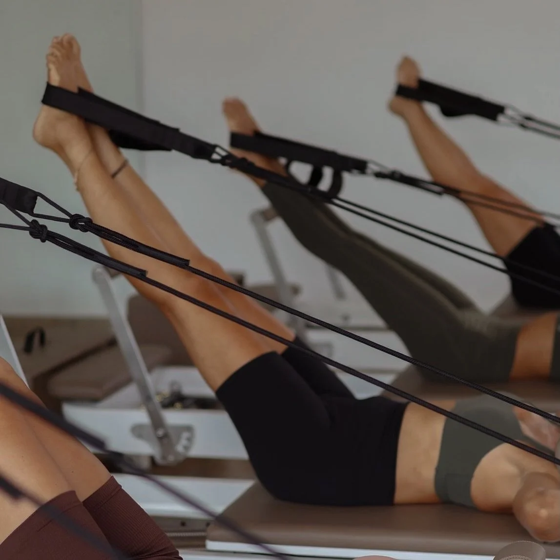 People exercising on the Reformer at Ōra Pilates on Spring Stuebner Rd, Spring, TX