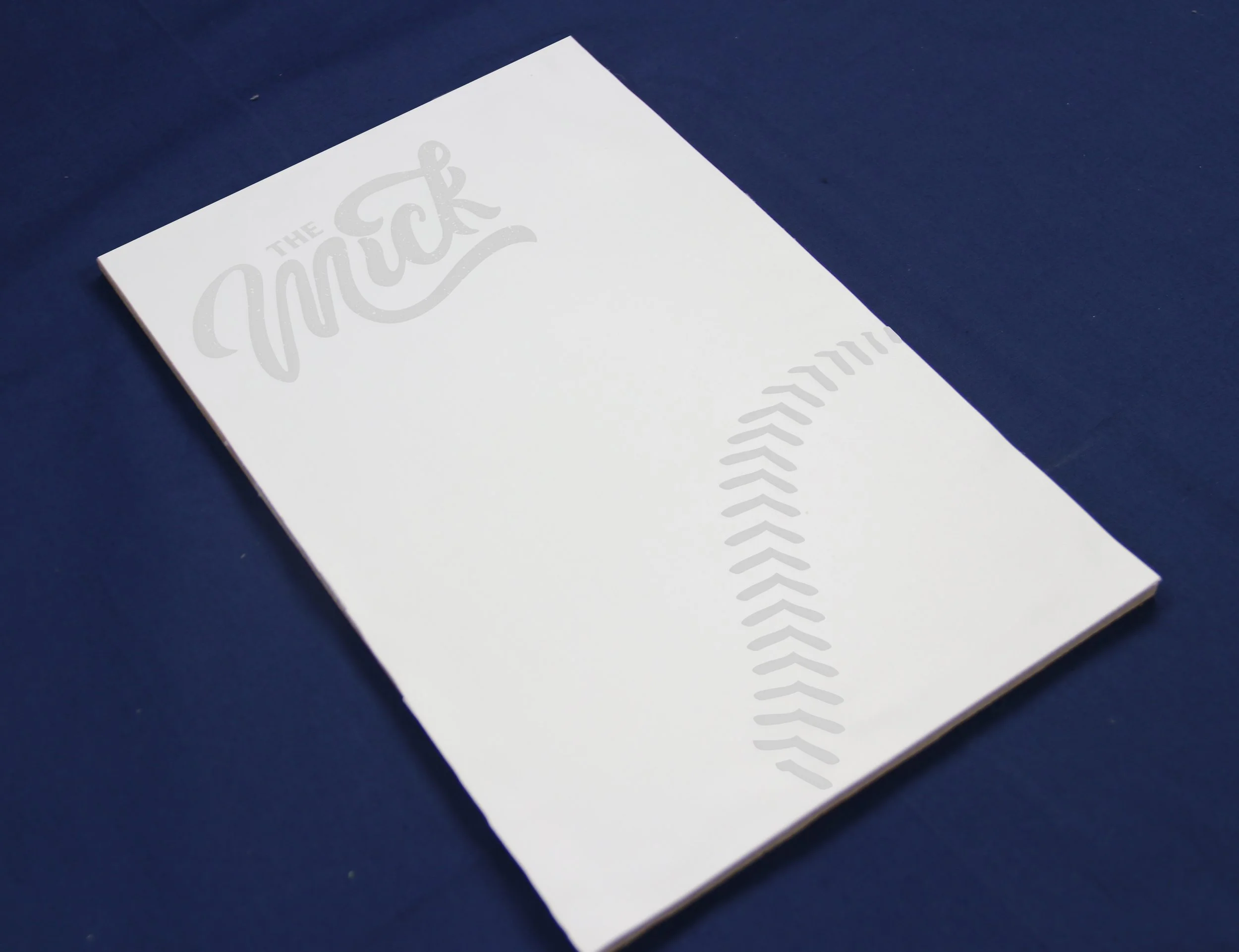Leather on back of menu embossed with The Mick logo and baseball stitching