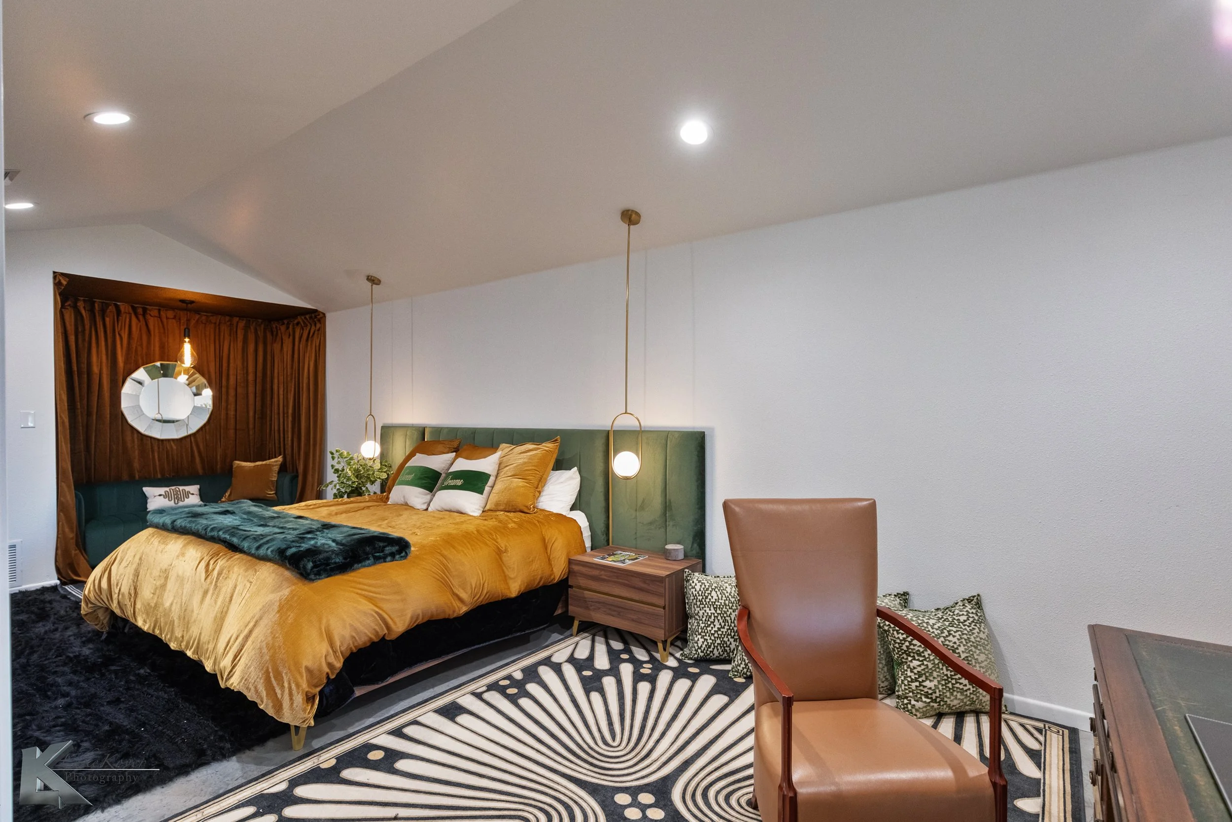 High ceilings and drop-down lamps add a modern touch to the primary bedroom.